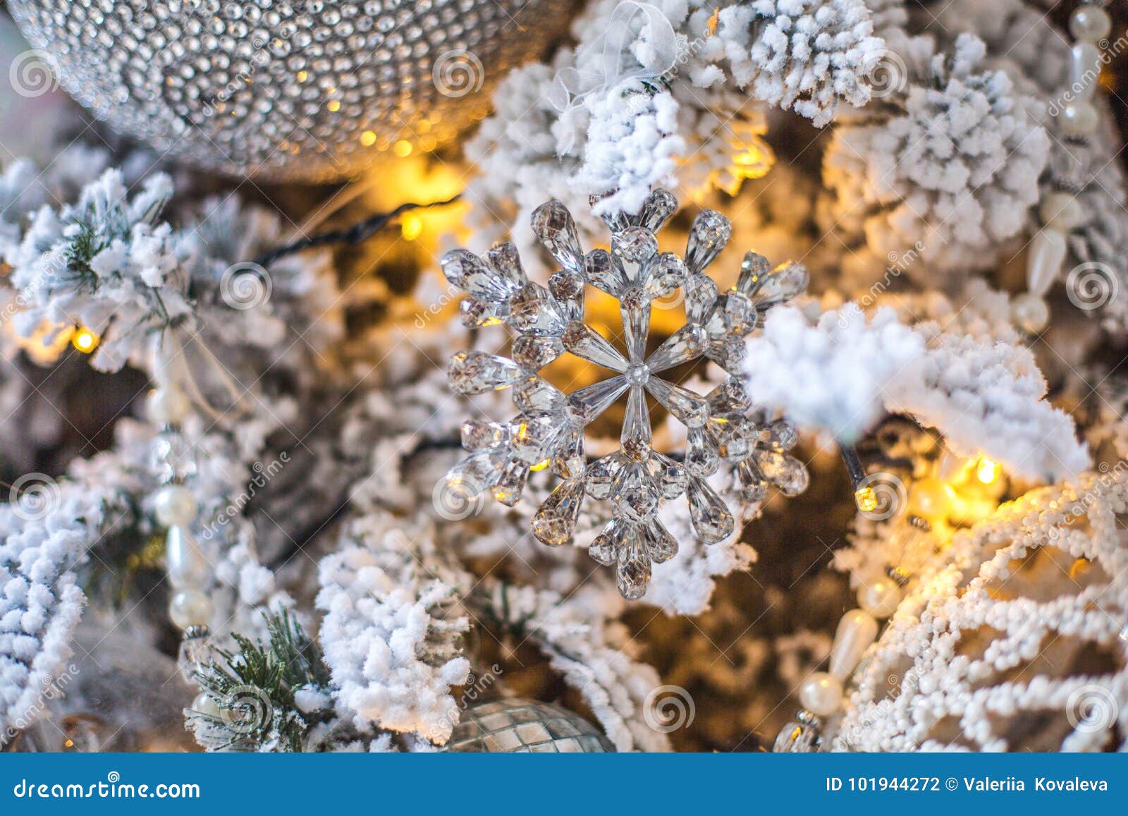 A Toy in the Form of a Snowflake on a Decorated Christmas Tree Stock