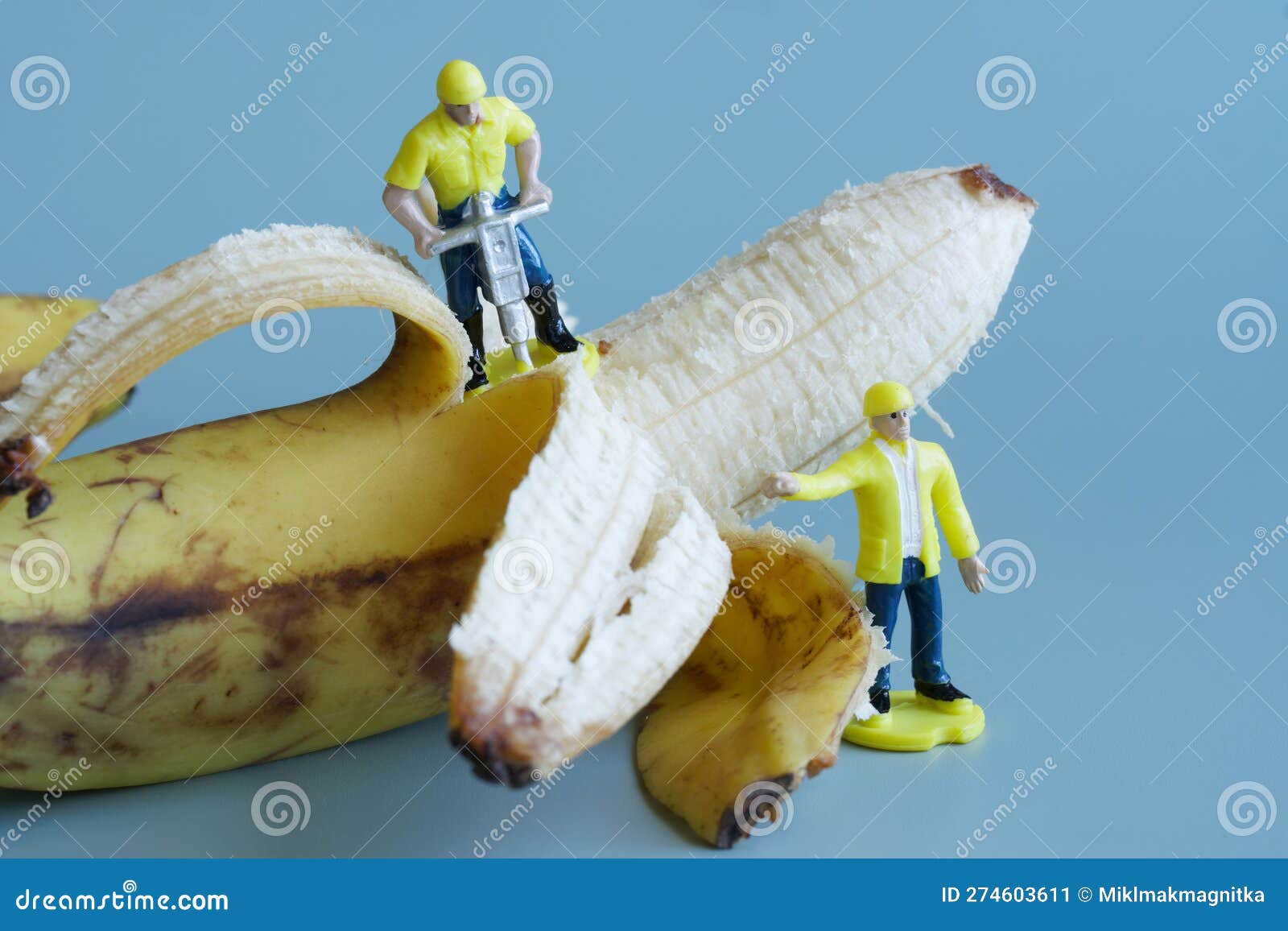 Toy People - Workers with a Jackhammer Peel a Yellow Overripe
