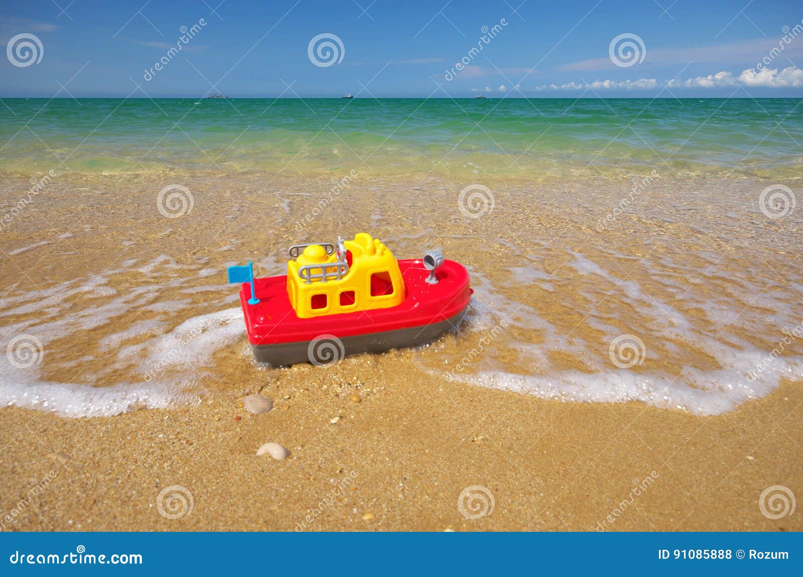 Toy ship on the sea shore. stock photo. Image of child 91085888