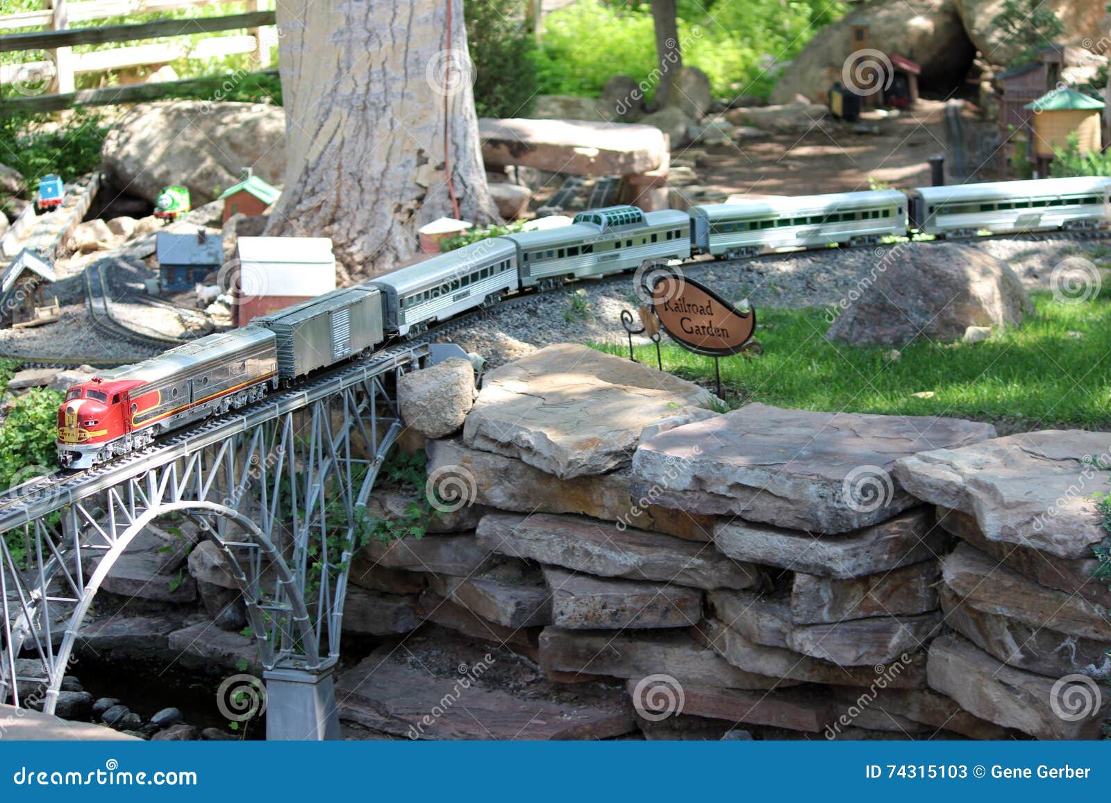 Toy Train through Garden editorial stock photo. Image of bridge 74315103