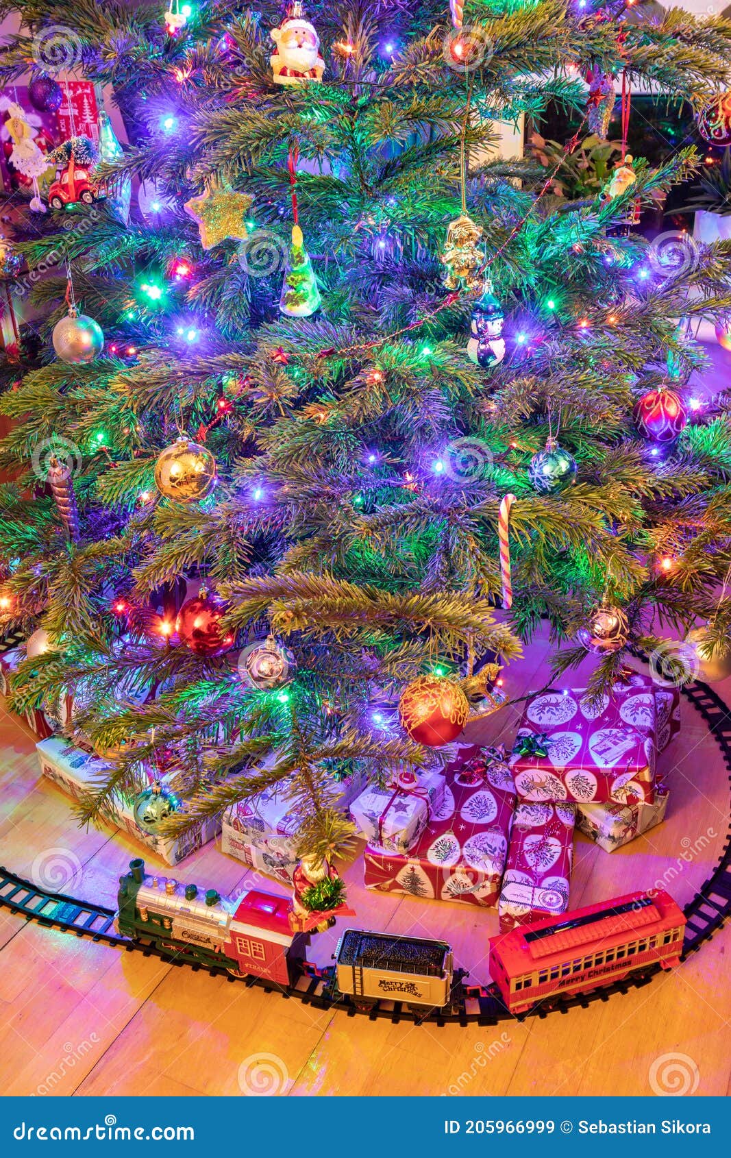 A Toy Train and Presents Under a Christmas Tree Stock Image Image of