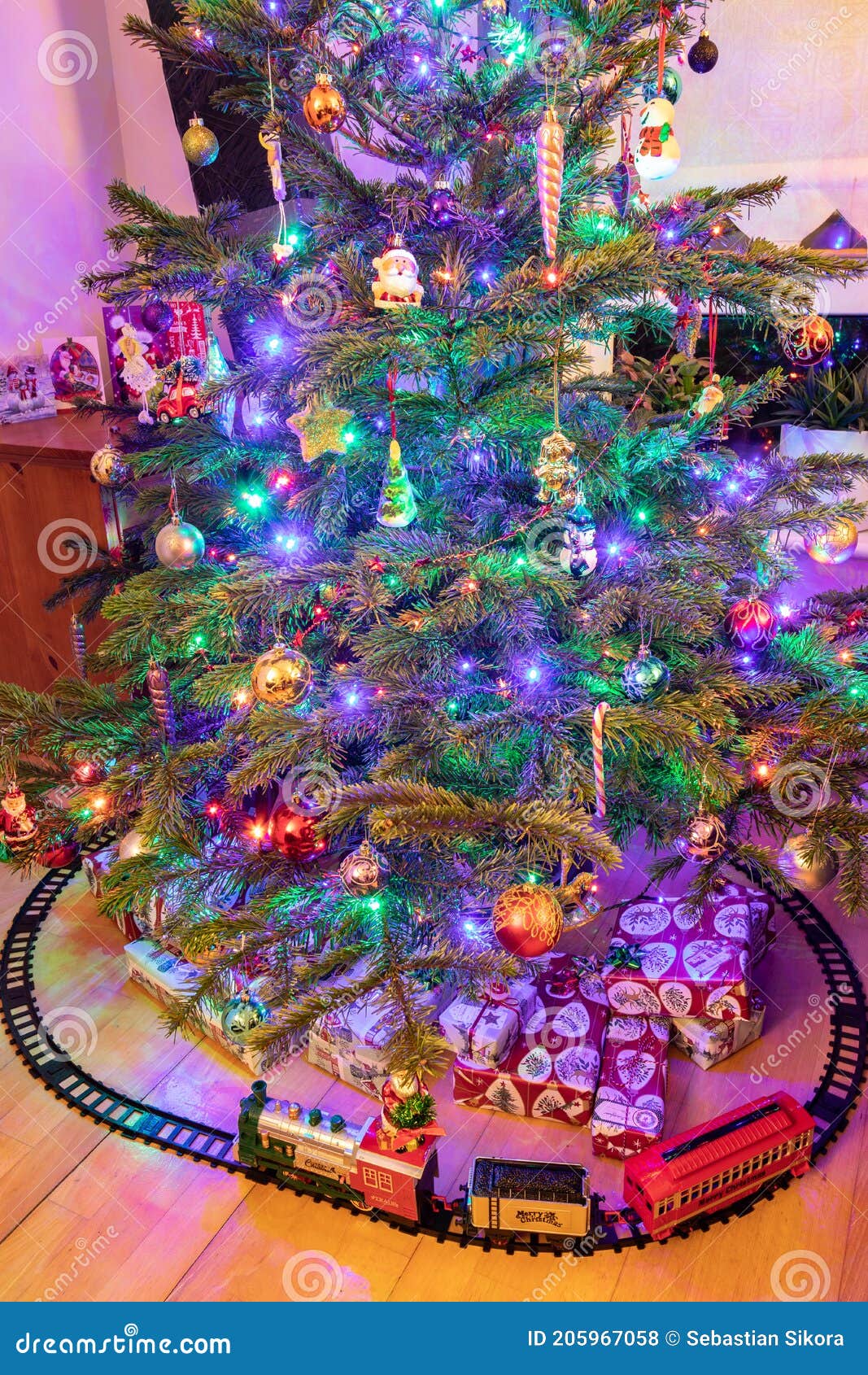A Toy Train and Presents Under a Christmas Tree Stock Photo Image of