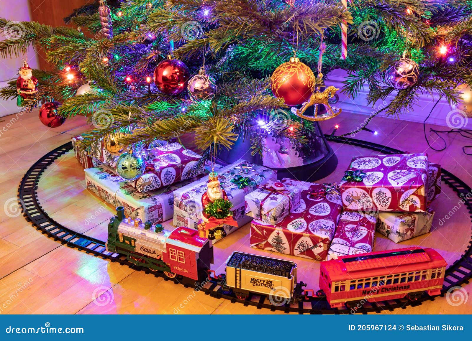 A Toy Train and Presents Under a Christmas Tree Stock Photo Image of