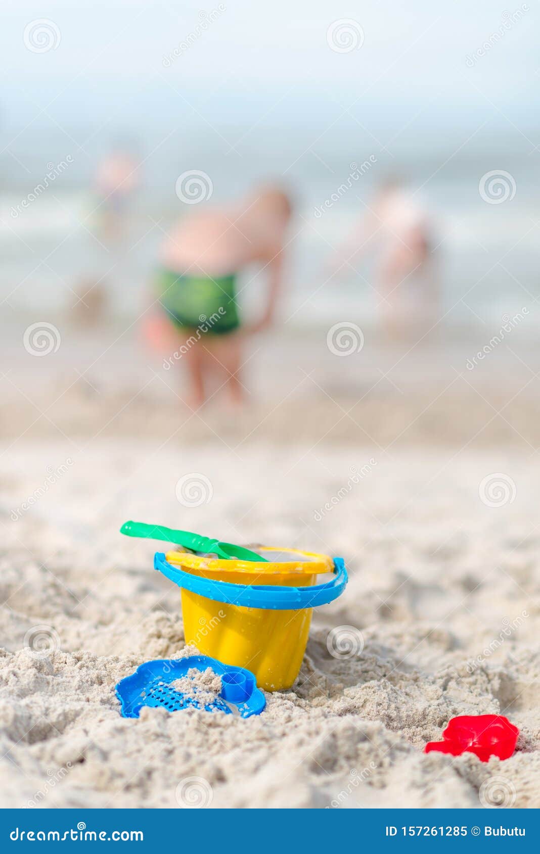 Toys at the Beach - Plastic Yellow Bucket, Rake, Spatula, Molds on a ...