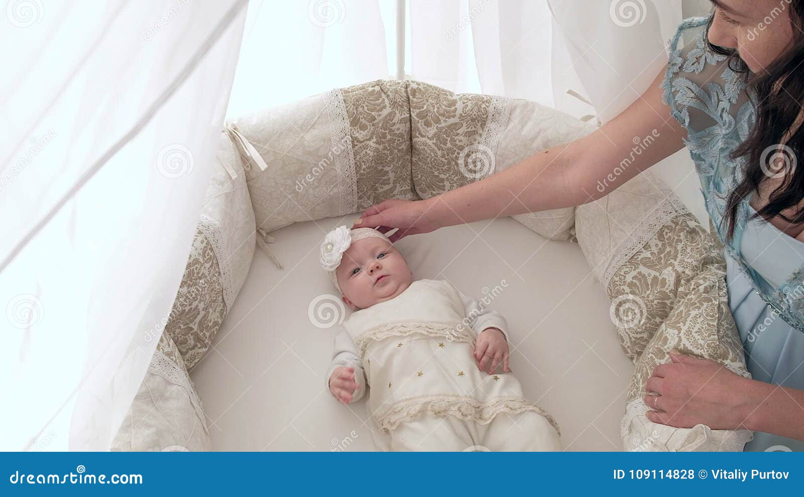 Tracking mother putting baby to sleep while walking . Attractive woman holding baby in hands and walk across living room. Tracking mother putting baby to sleep while walking 4K. Attractive women holding baby in hands and walk across living room with bright window curtains in background.