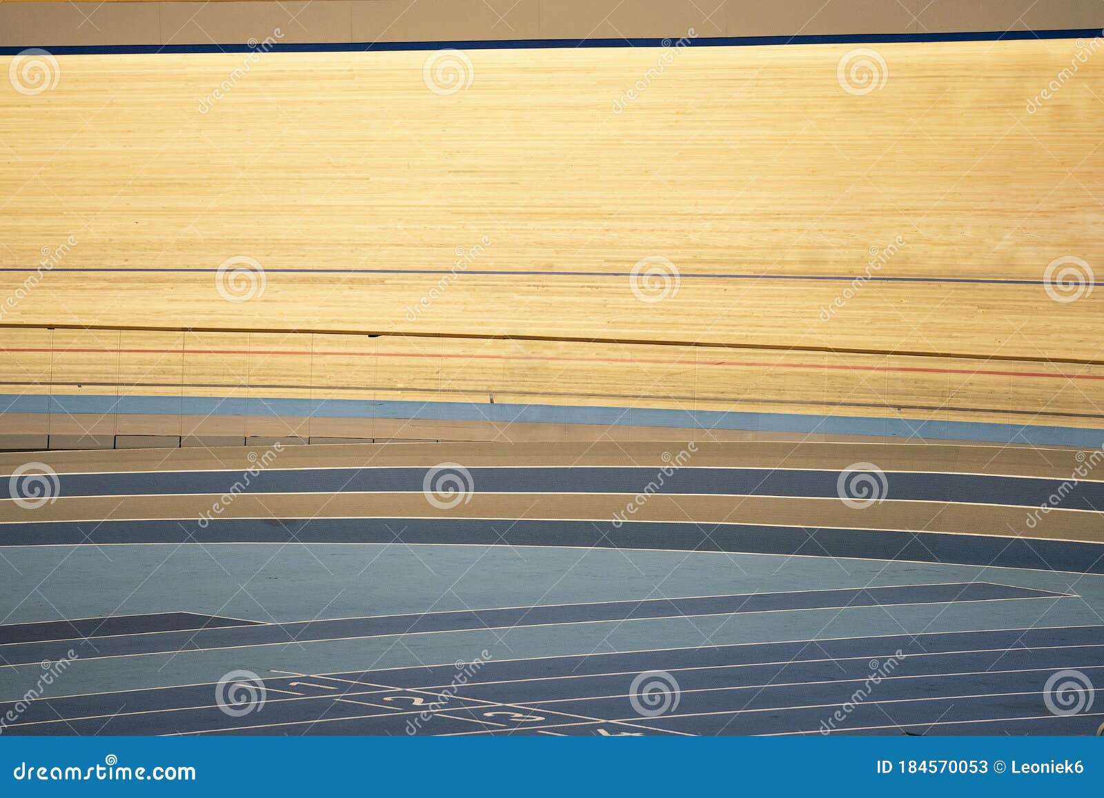 tracks of an indoor track cycling velodrome with wooden course race-track and a blue floor