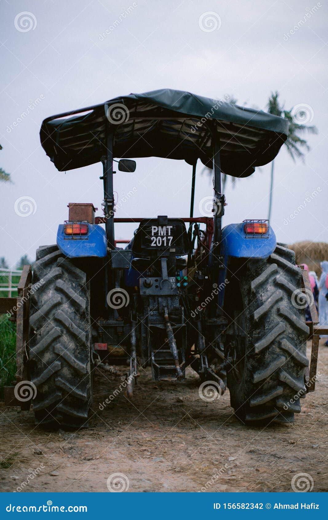 Blue tractor in the farm editorial photography. Image of farming