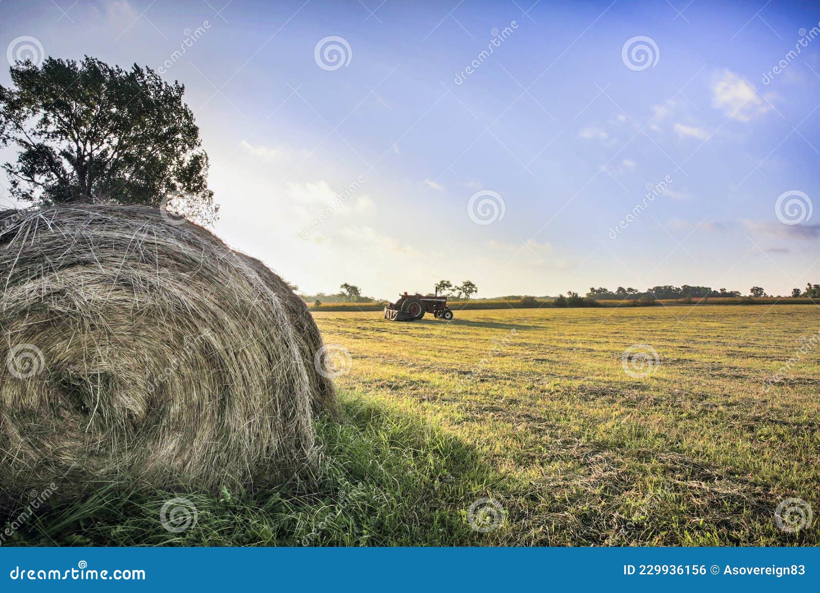 Tractor Baling Hay in a Nebraska Field. Stock Photo Image of