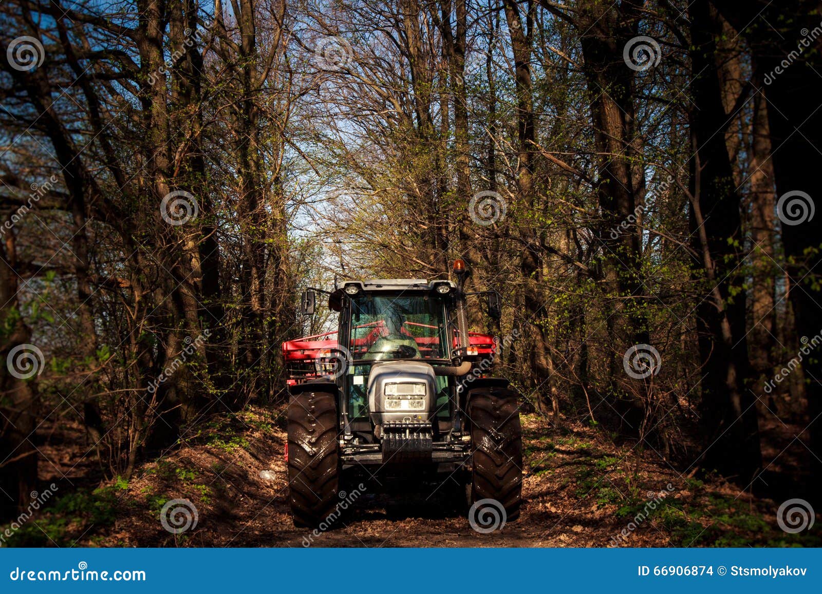 Tractor on Big Wheels on Soil Road in Spring Forest Stock Photo Image of large, land 66906874