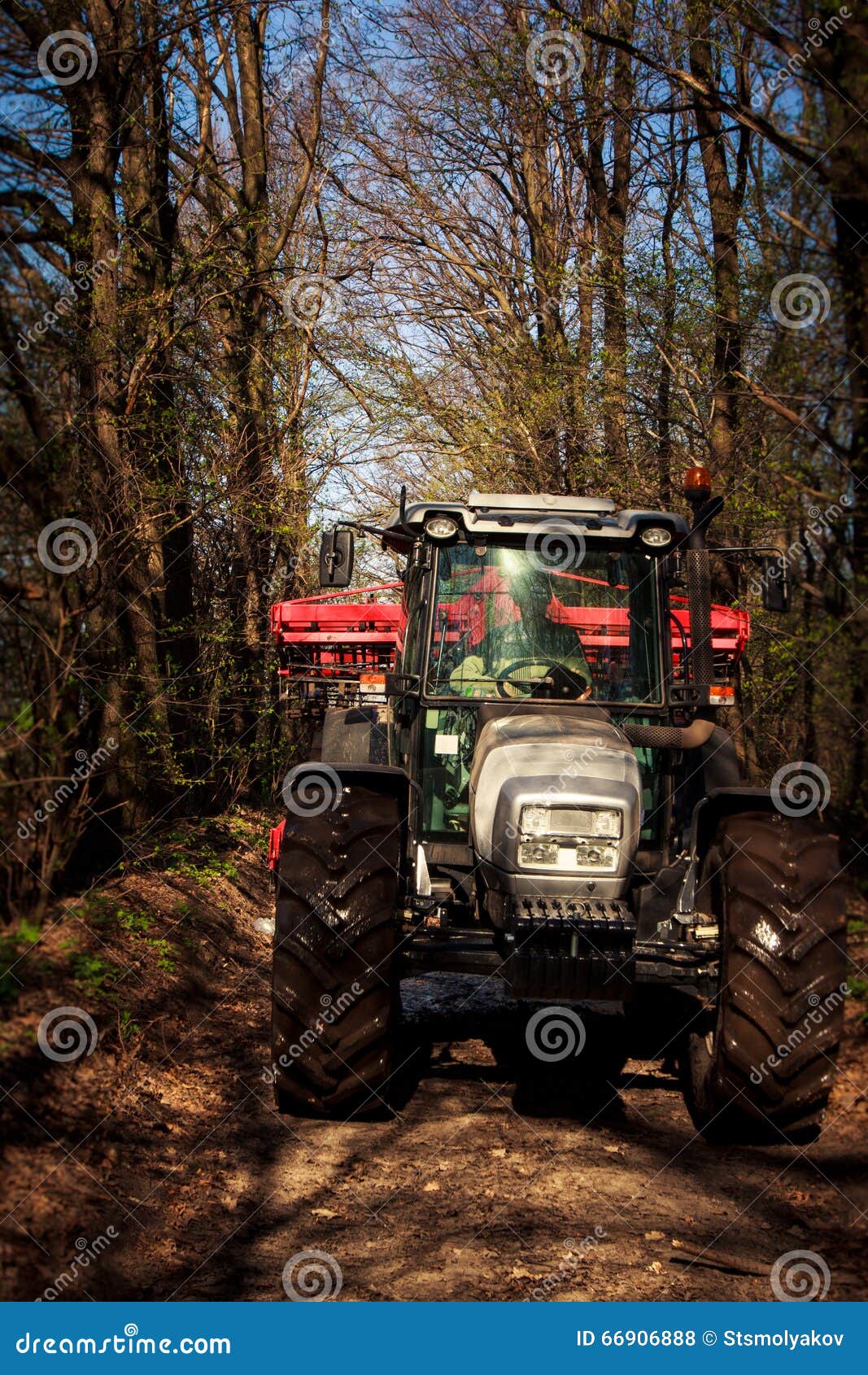 Tractor on Big Wheels on Soil Road in Spring Forest Stock Photo Image of cowl, large 66906888