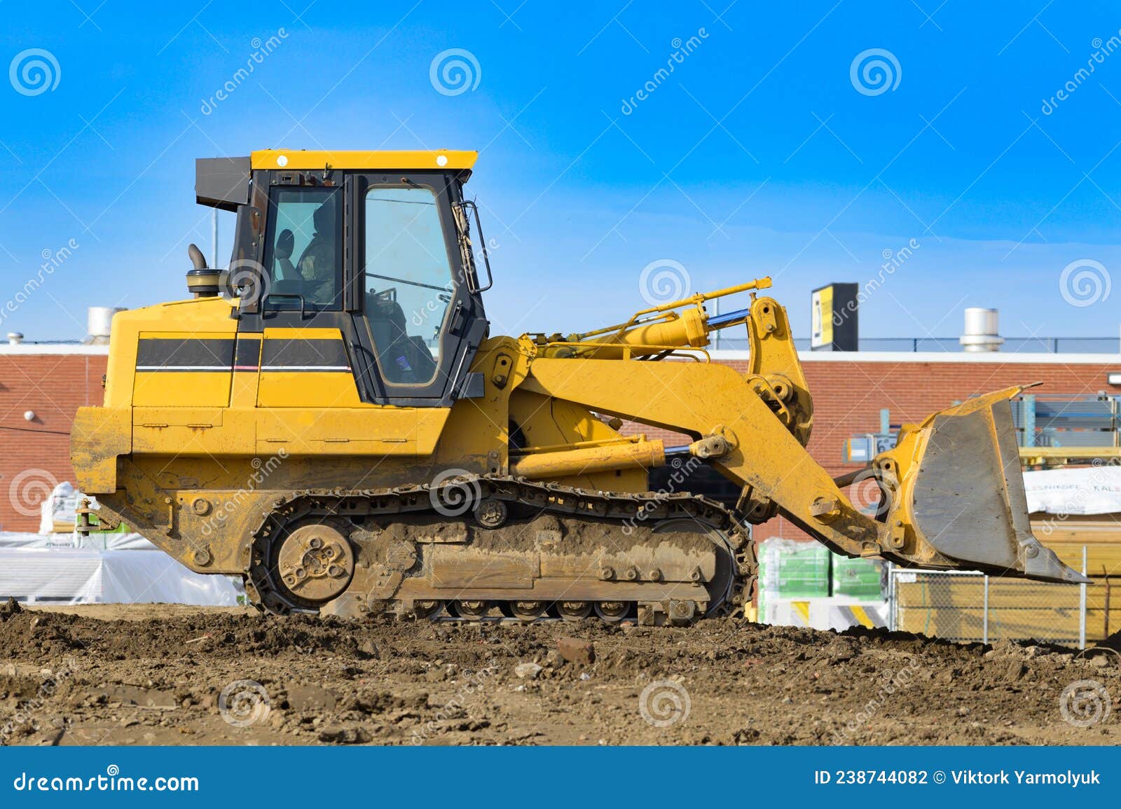 Tractor on a Construction Site Bulldozer Work Shovel Stock Photo