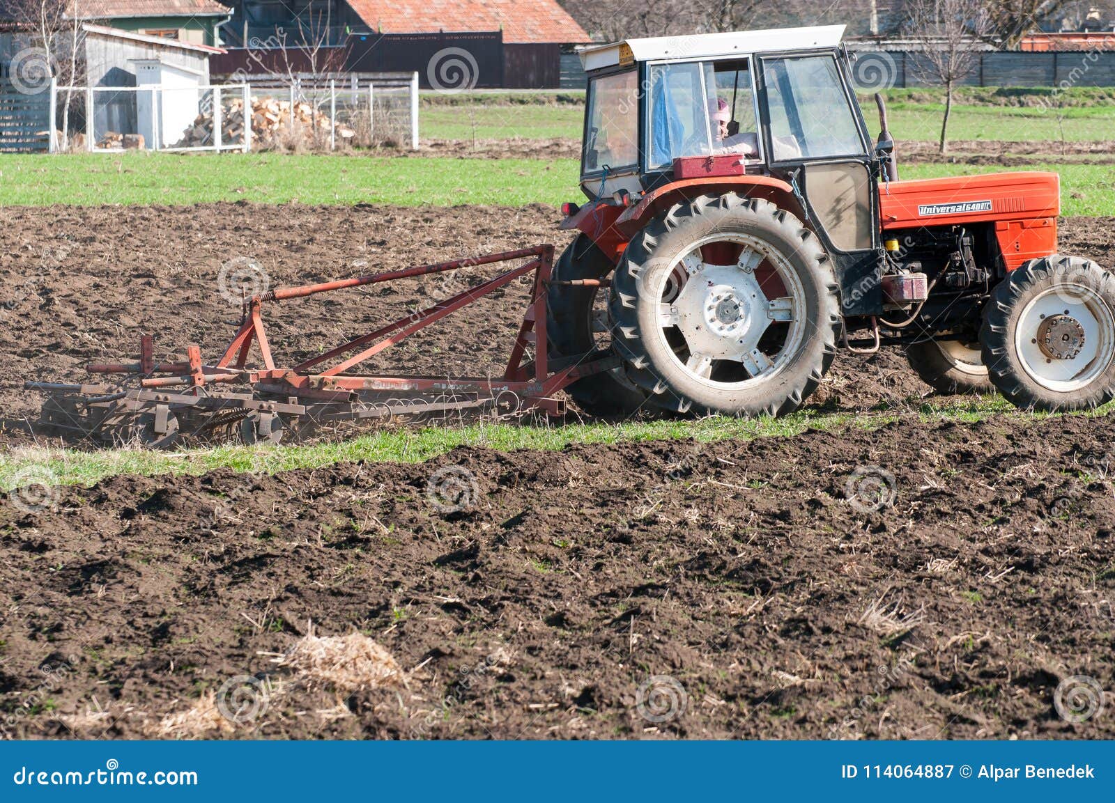 Tractor Equipped with Harrow Working on the Field Editorial Photography