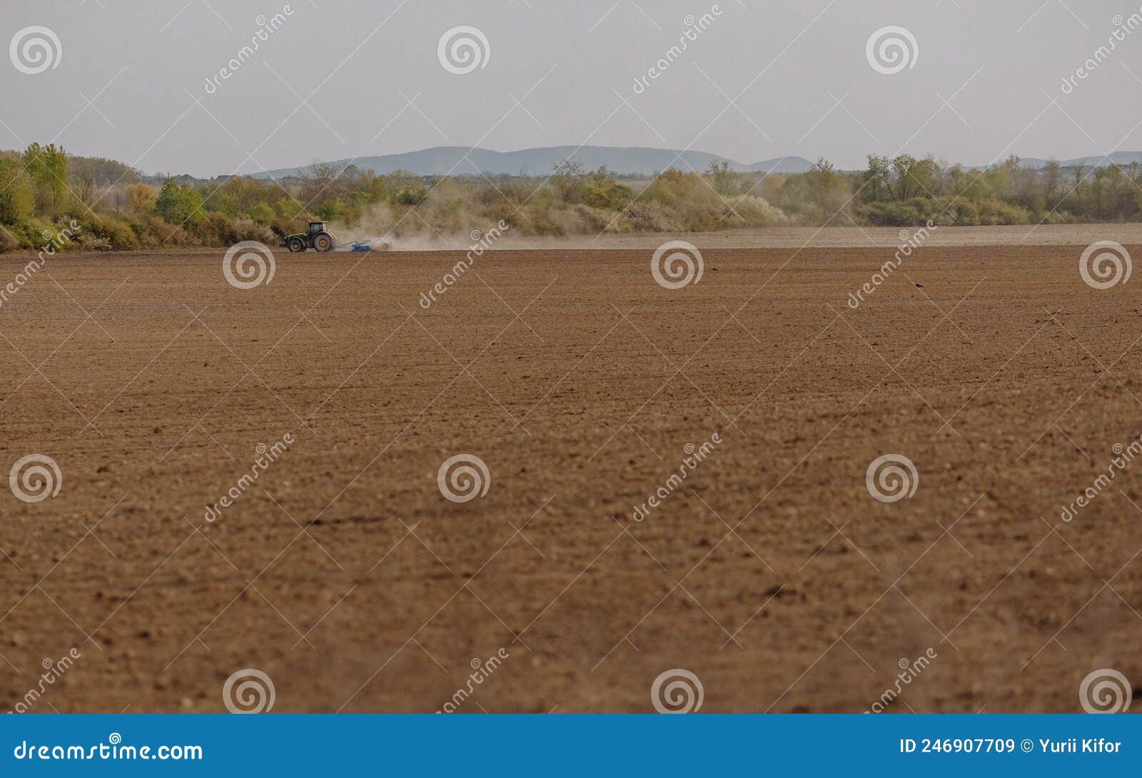 The Tractor Finishes Plowing the Field. Tractor in a Field on a Farm