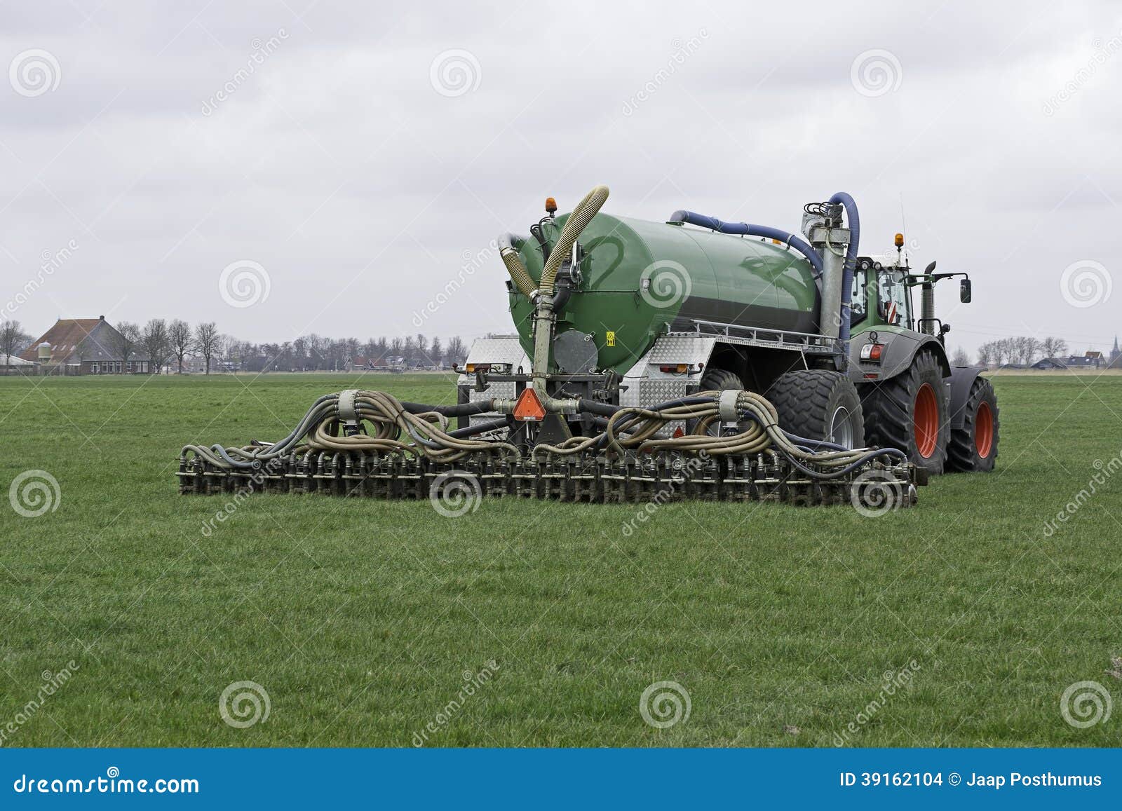 tractor injects liquid manure in a meadow