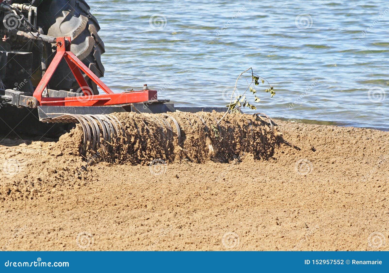 Tractor with Large Metal Rake Attached Sifting, Raking and