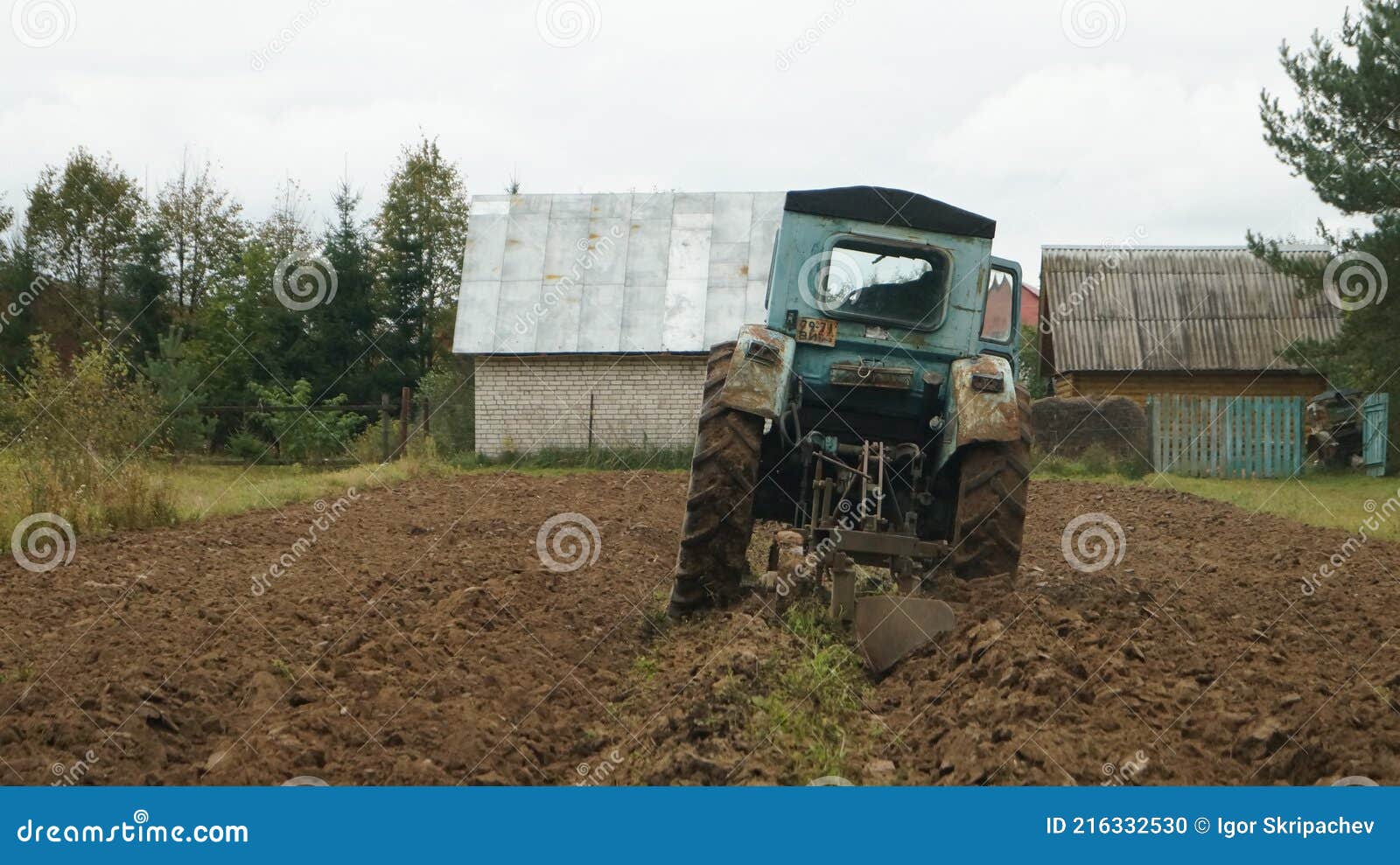 Tractor Ploughs Arable Land, an Agricultural Concept Stock Photo