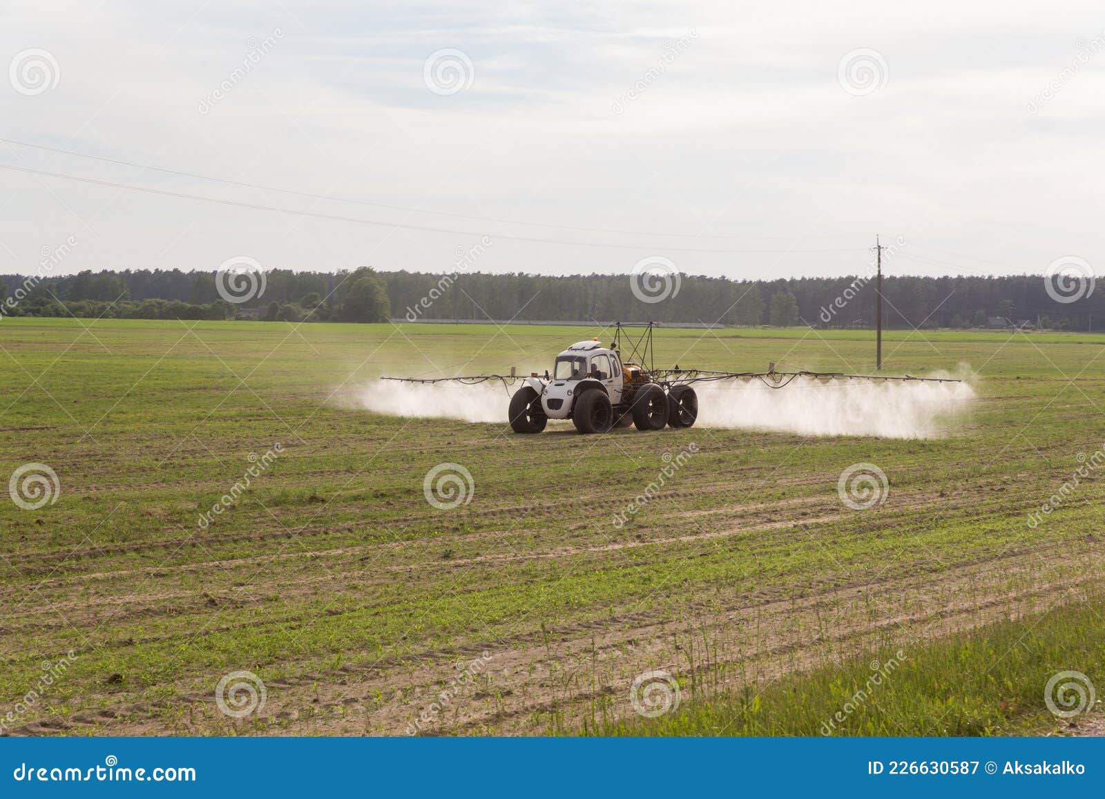 tractor sprays liquid chemical fertilizers