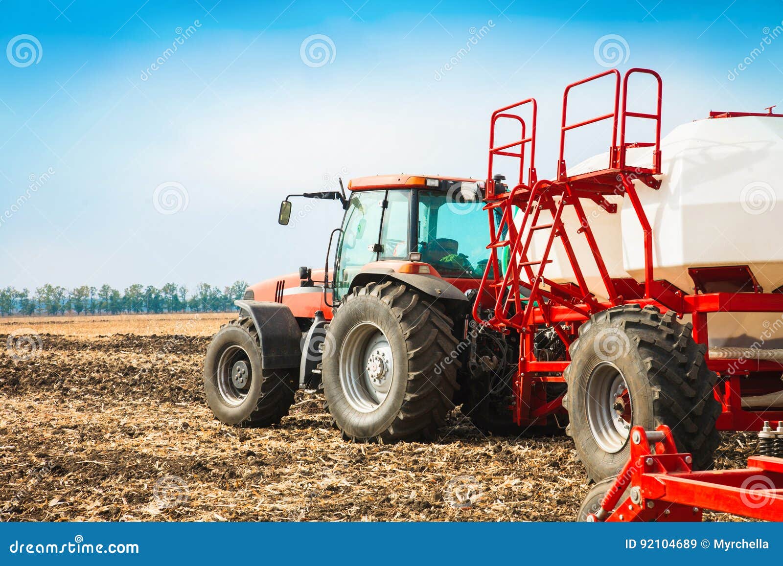 tractor with tanks in the field. agricultural machinery and farming.