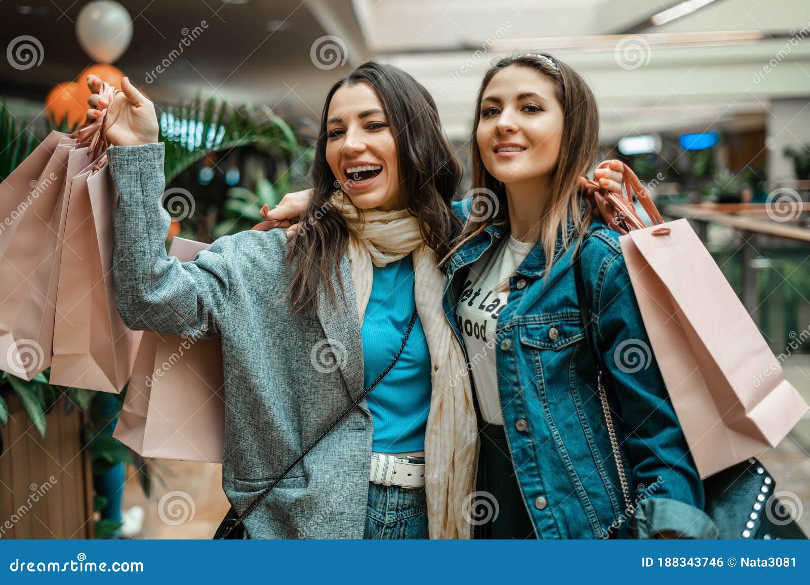 Trade, Buyers. Two Beautiful Girls Make Purchases in a Shopping Center ...