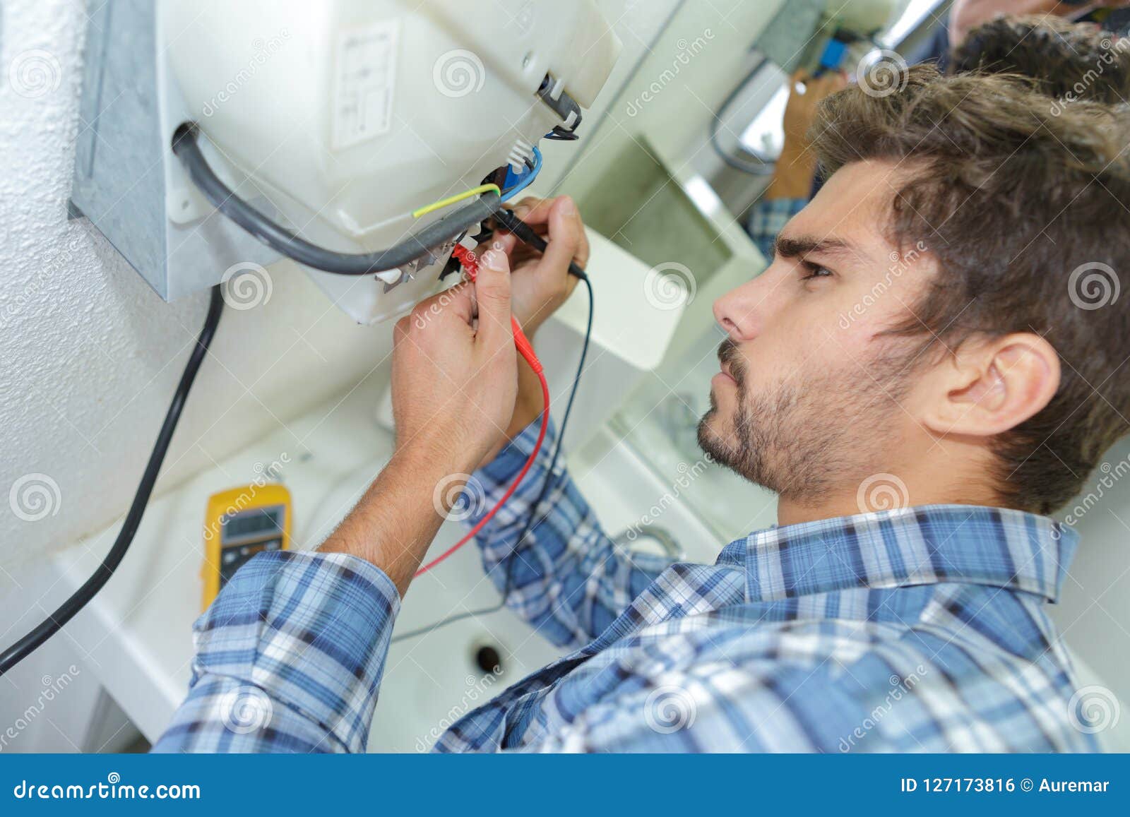 Tradesman Fixing Electrical Issue with Hand Dryer