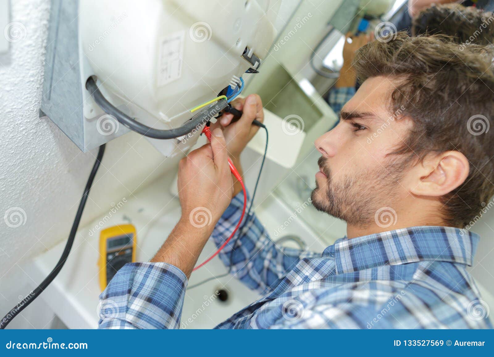 Tradesman Fixing Electrical Issue With Hand Dryer