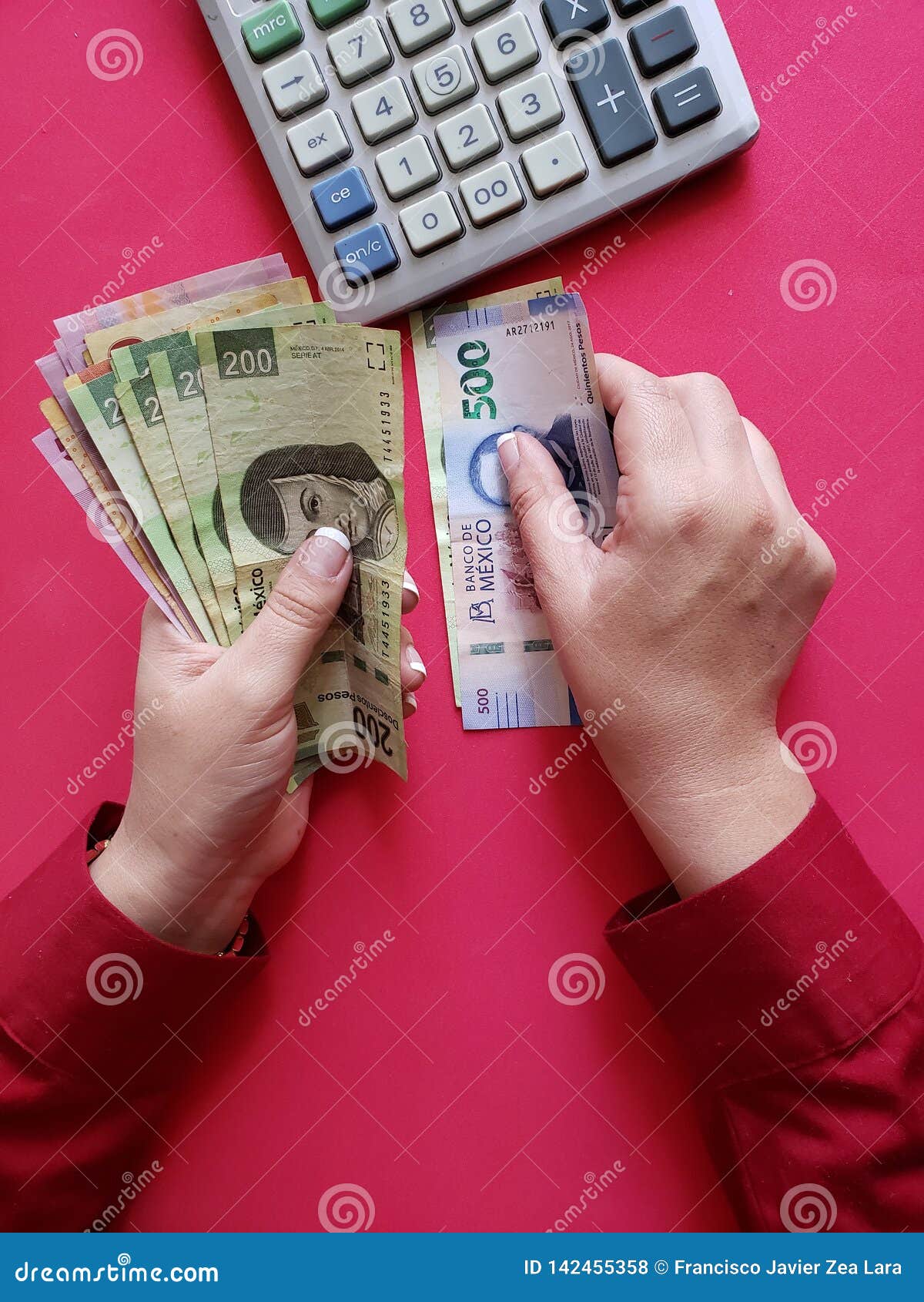 hands of a businesswoman counting mexican banknotes