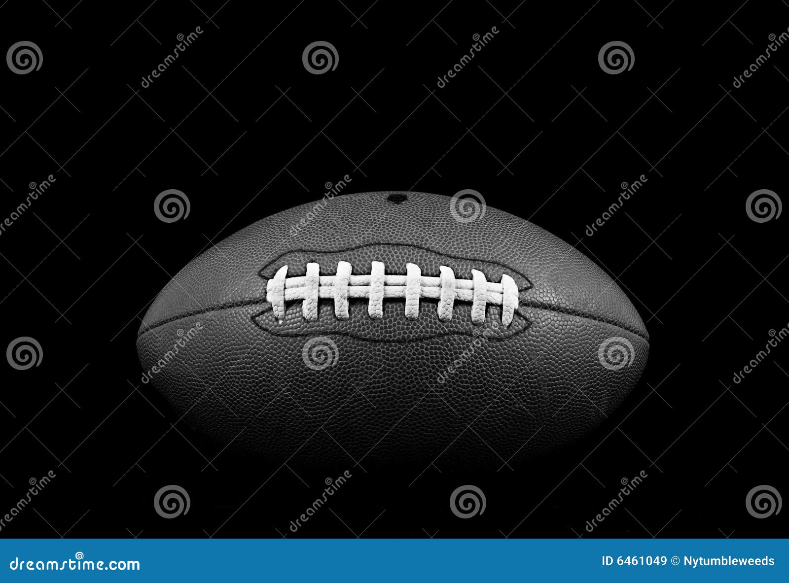 Traditional American Football. Black &amp; white dramatic leather football on black