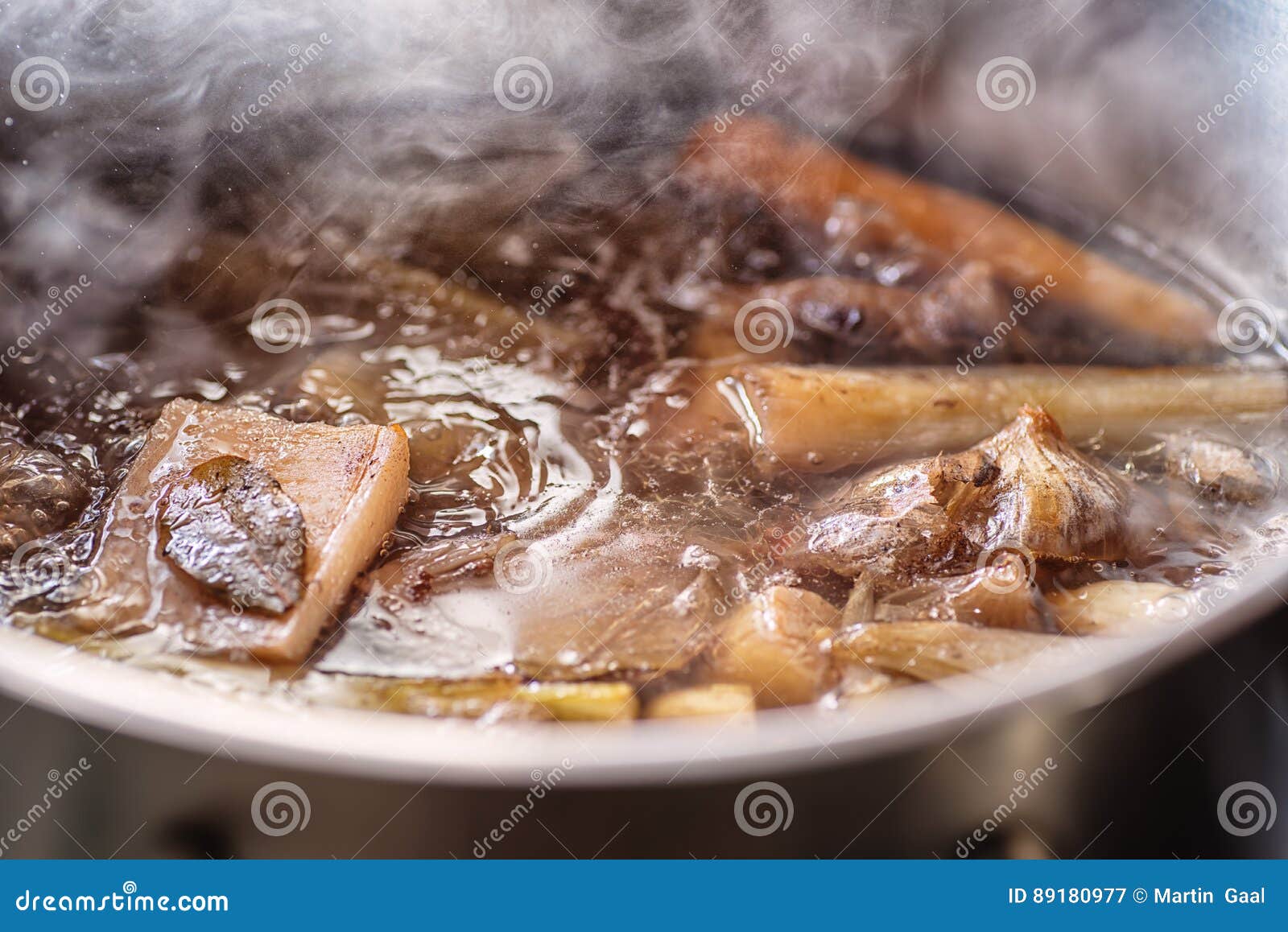 Traditional Beef Broth with Vegetable, Bones and Ingredients in Pot