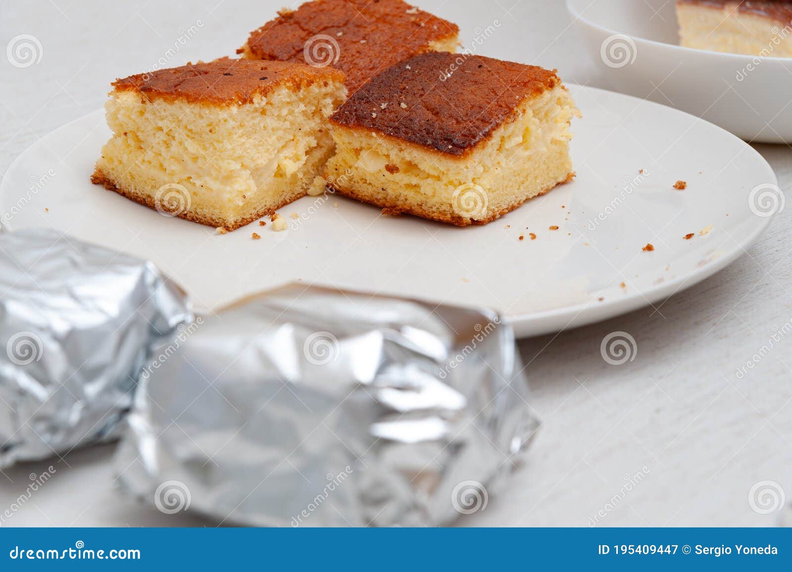 traditional brazilian dessert known as bolo gelado - making step by step: cake pieces wrapped and not wrapped in aluminum foil