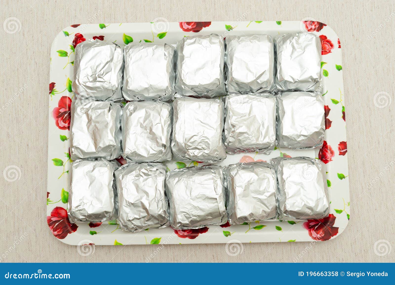 traditional brazilian dessert known as bolo gelado in portuguese - making step by step: cakes wrapped in aluminum foil