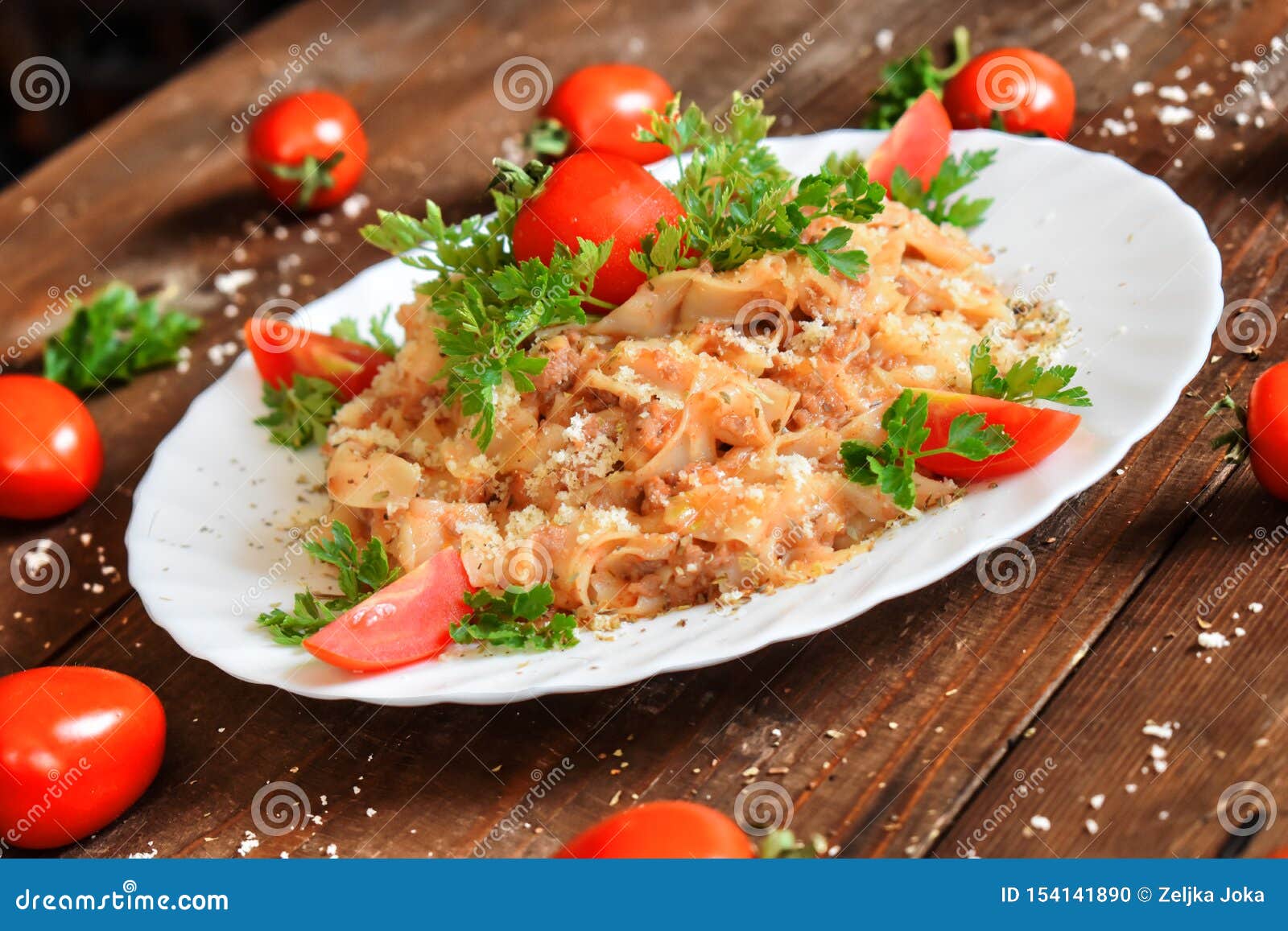 Italian Cheese and Tomato Pasta Covered with Parmesan. Stock Photo