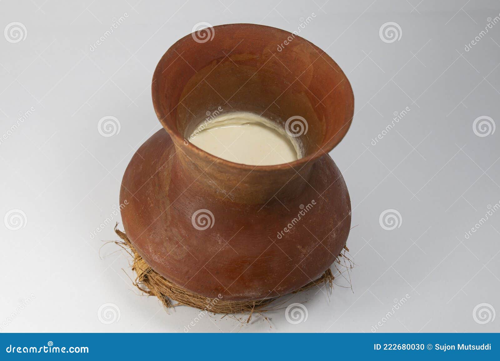 A Traditional Clay Pot of Curd or Yogurt Placed on Coconut Fiber Base