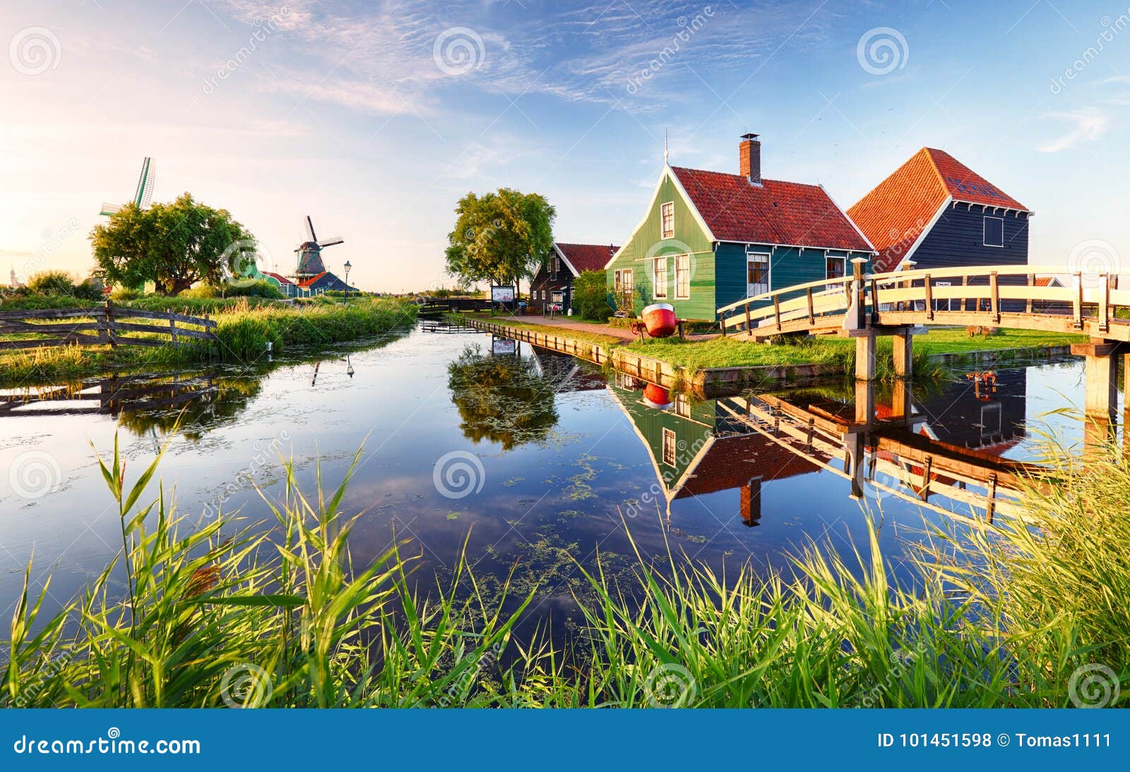 traditional dutch windmill near the canal. netherlands, landcape at sunset