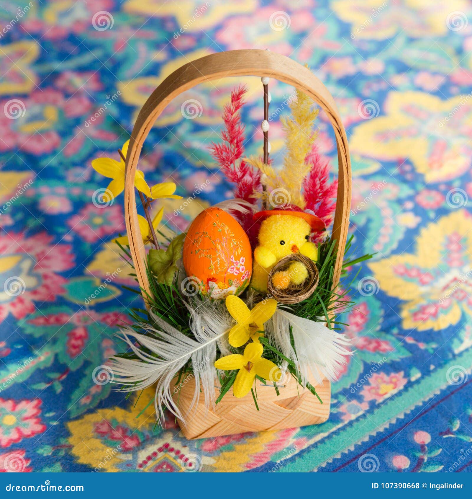 Traditional Easter Basket with Painted Egg and Decorations Stock Photo