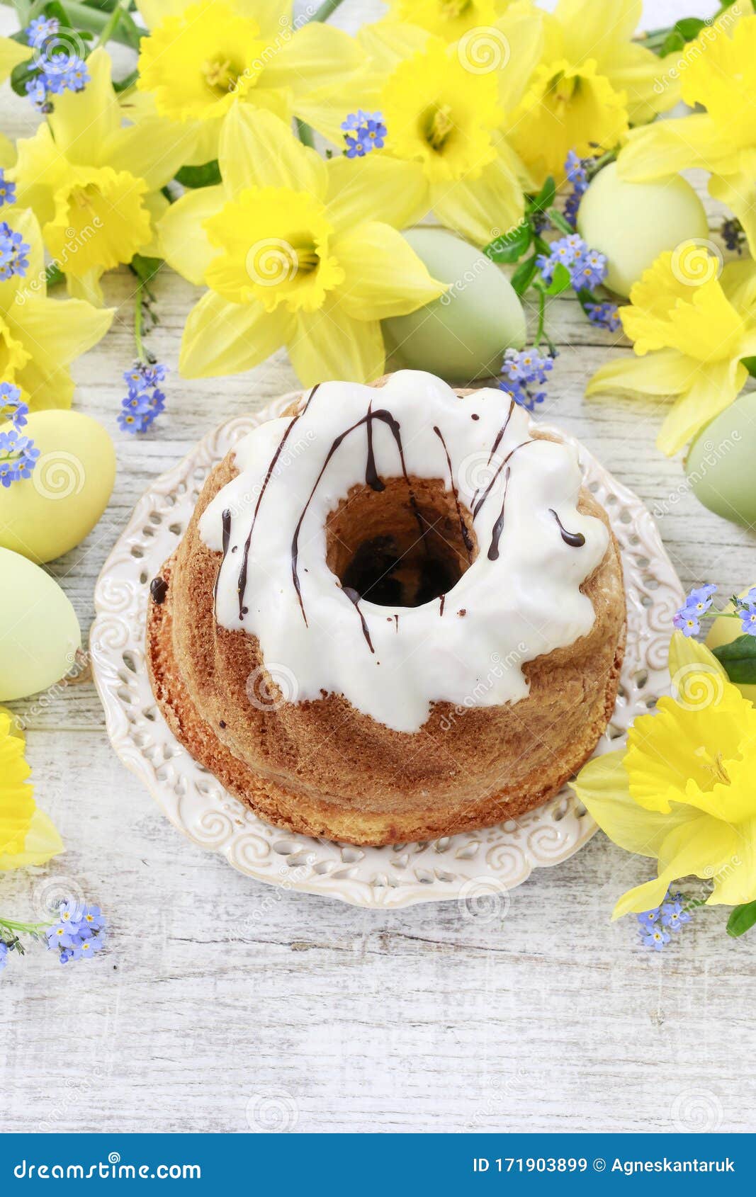 Traditional Easter Cake and Bouquet of Daffodils in the Background