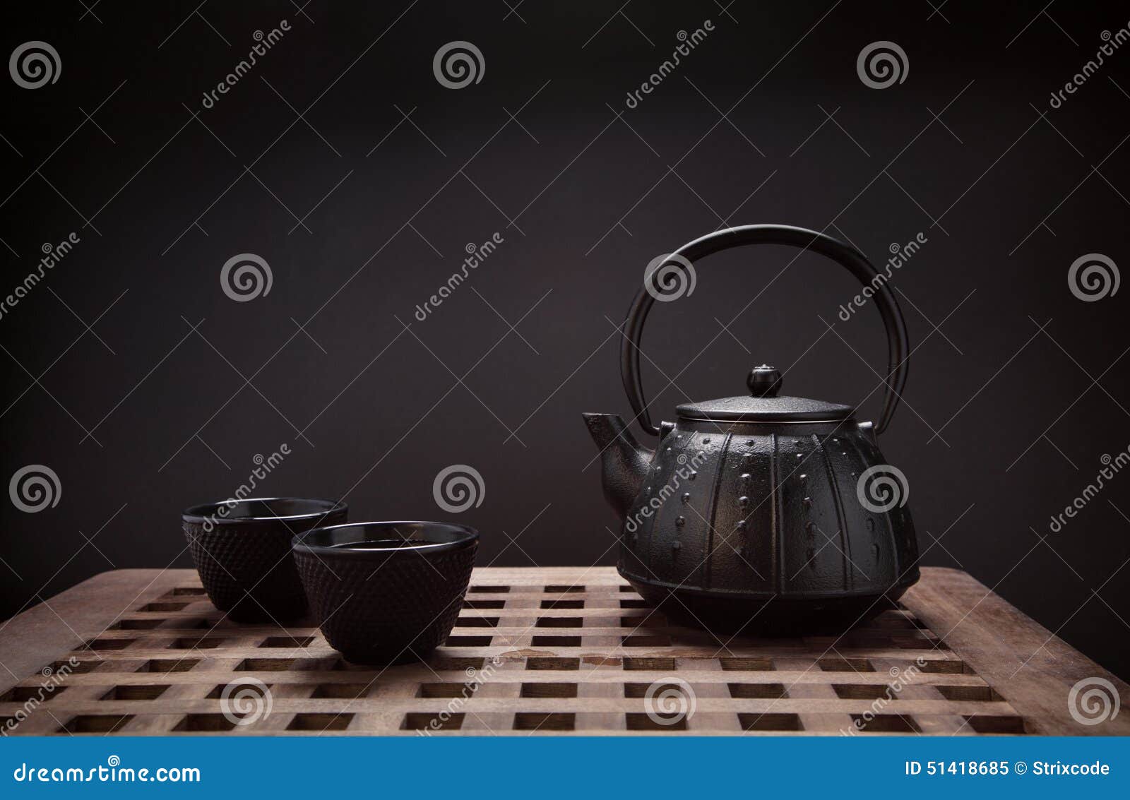 Traditional Eastern Teapot and Teacups on Wooden Desk Stock Image