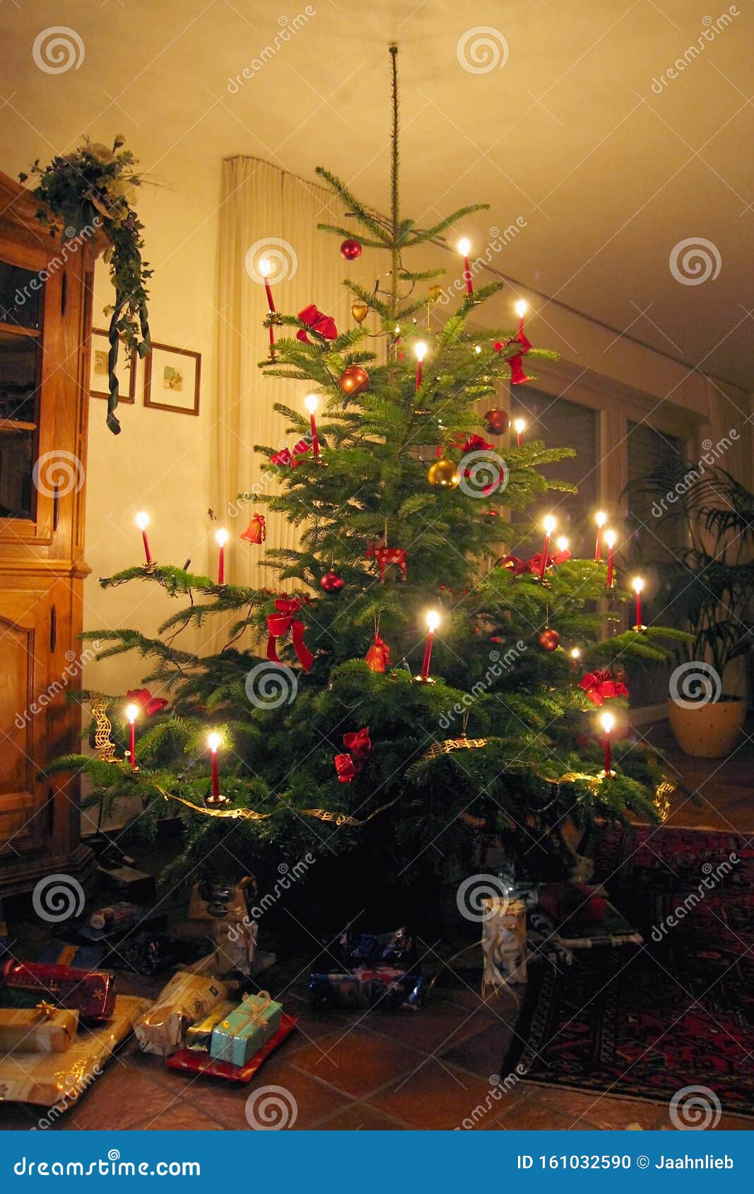 Traditional European Christmas Tree With Candles Burning And Presents ...