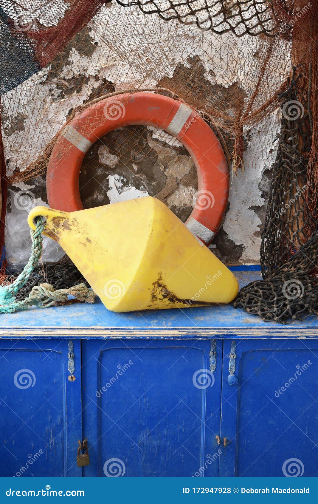 Traditional Fishing Equipment of Life Saver Ring, Weight, Ropes and Nets on  Blue Wooden Chest Stock Photo - Image of mediterranean, collection:  172947928