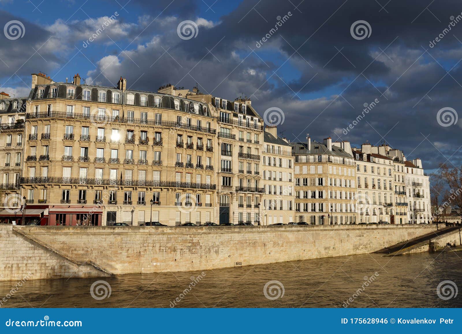 the traditional french house with typical balconies and windows located on parisian quay . paris