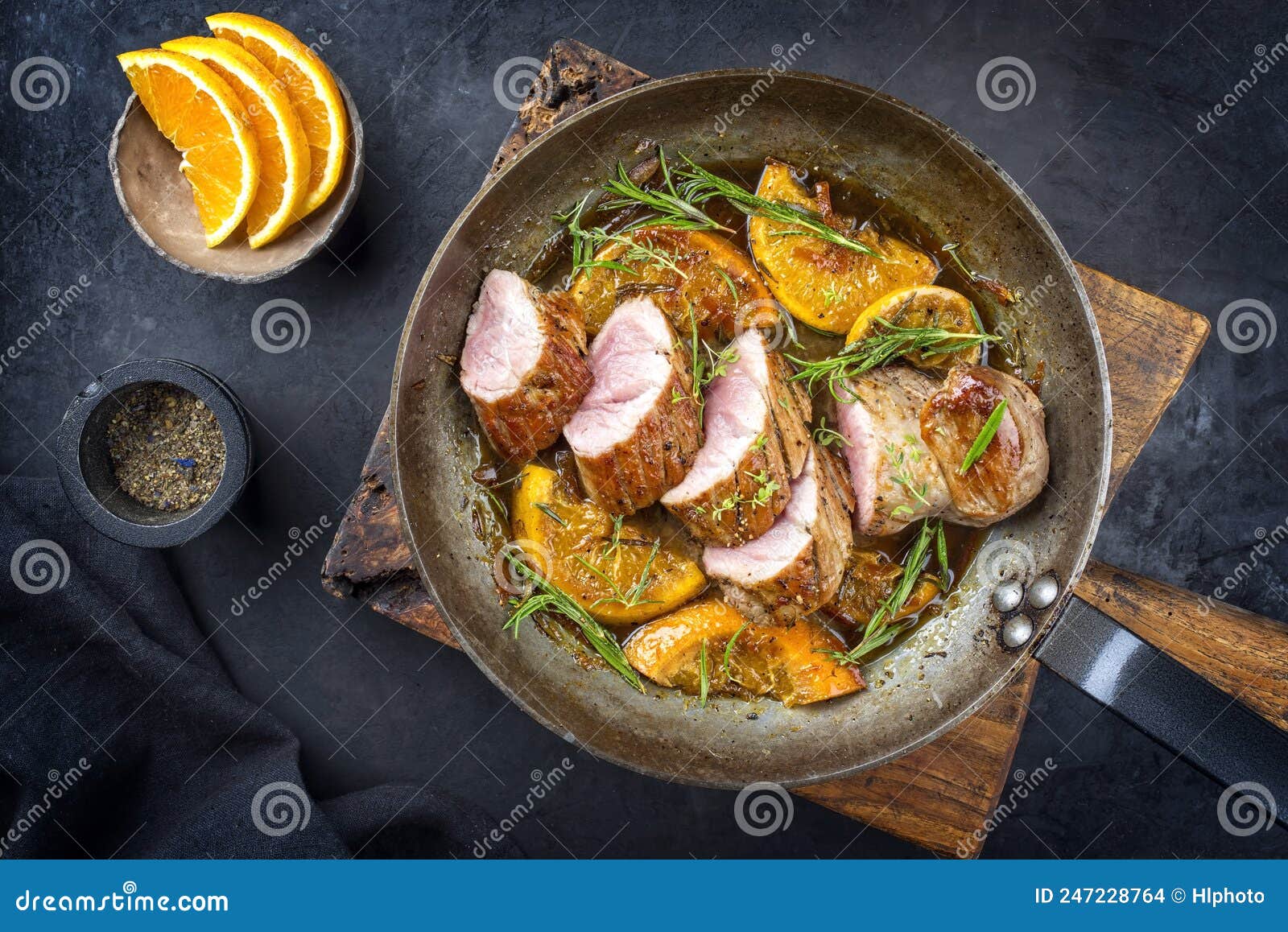 Traditional Fried Pork Filet Medaillons in with Orange Slices and Herbs ...