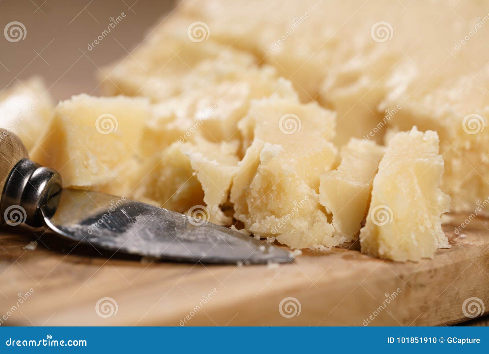 traditional grana padano italian cheese on olive board