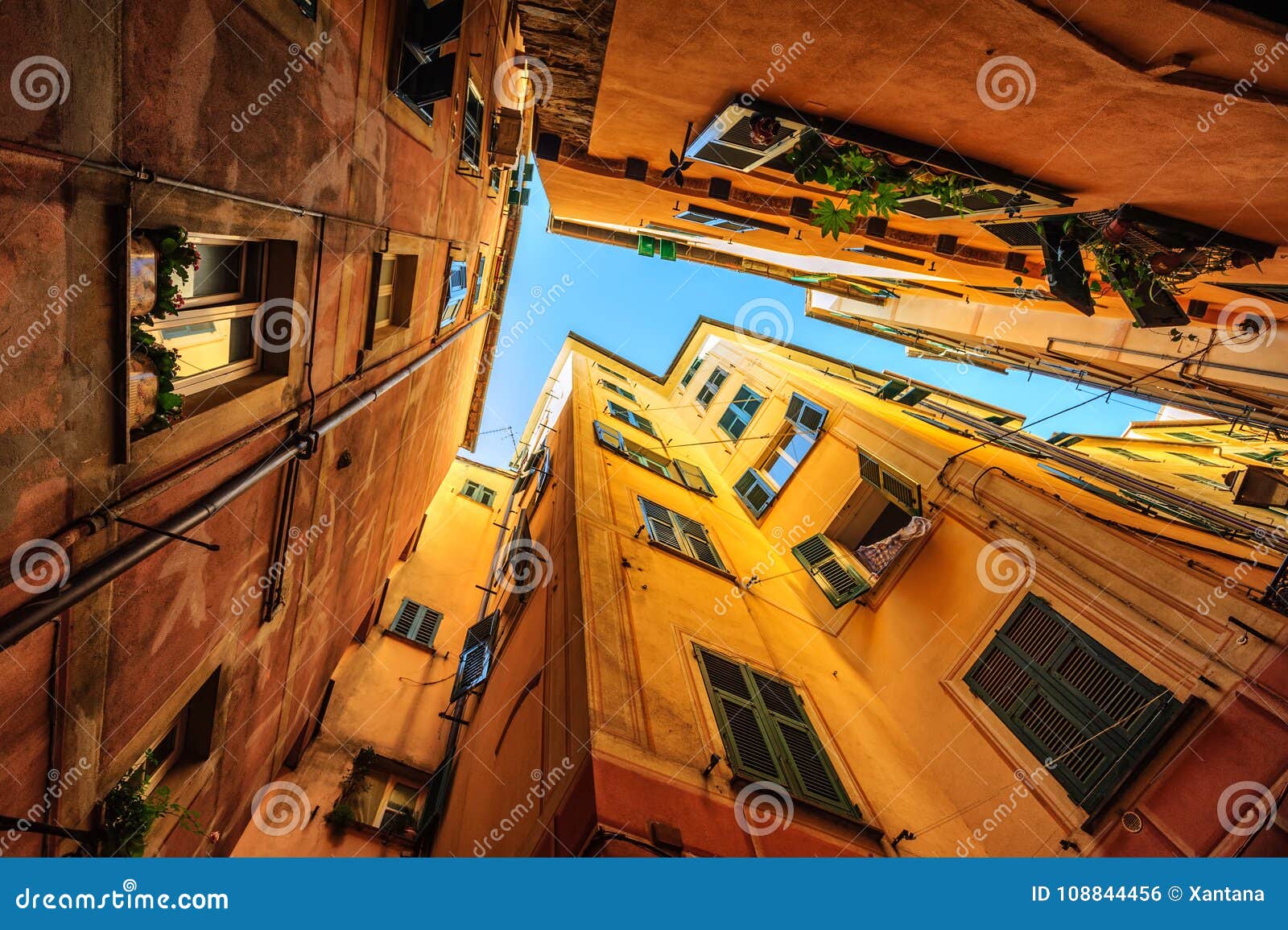 traditional houses in a narrow street in genoa, italy