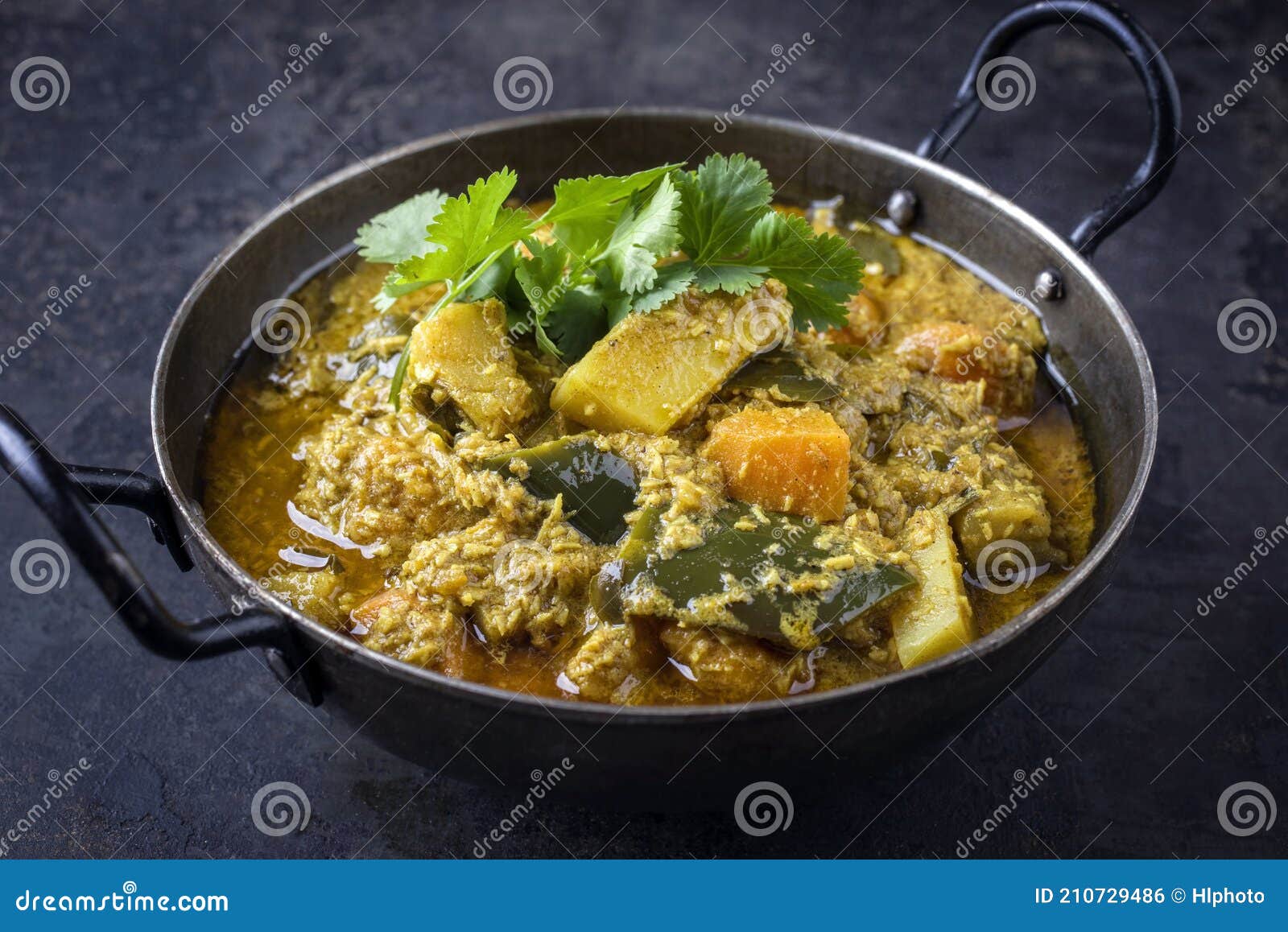 Traditional Indian Sweet Potato Curry with Eggplant in a Design Bowl