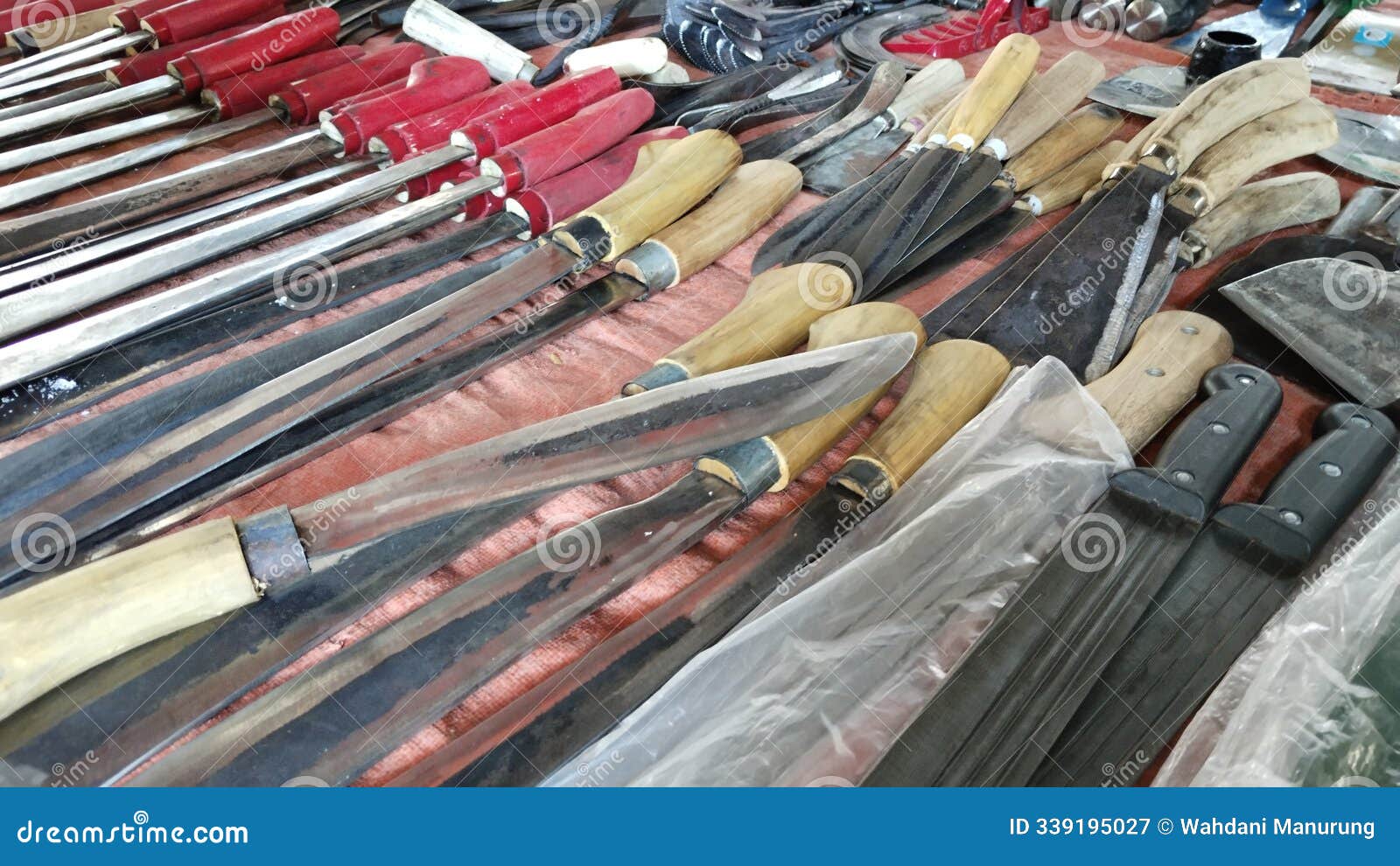 traditional knives and machetes displayed at market stall