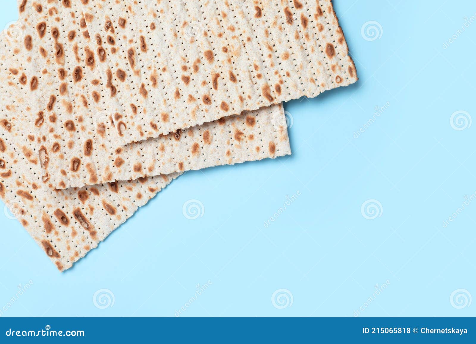 Traditional Matzos on Light Blue Background, Flat Lay. Space for Text