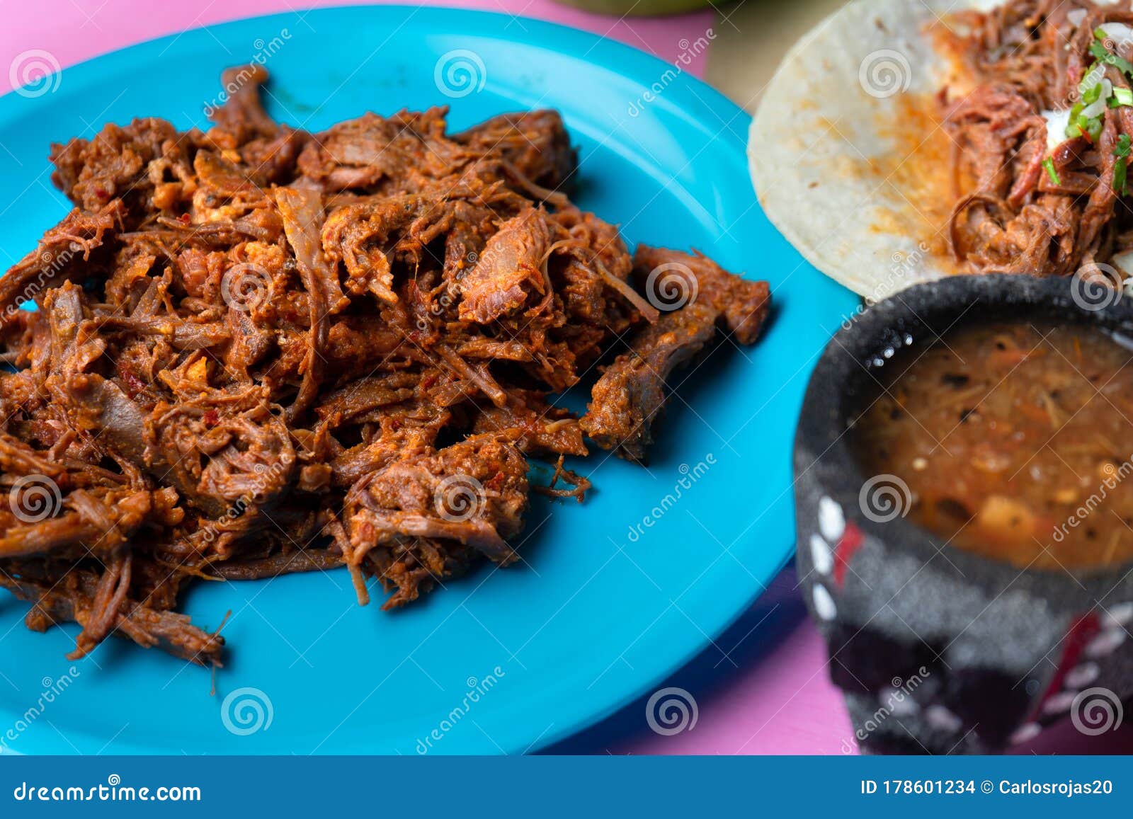 mexican beef barbacoa tacos on colorful background