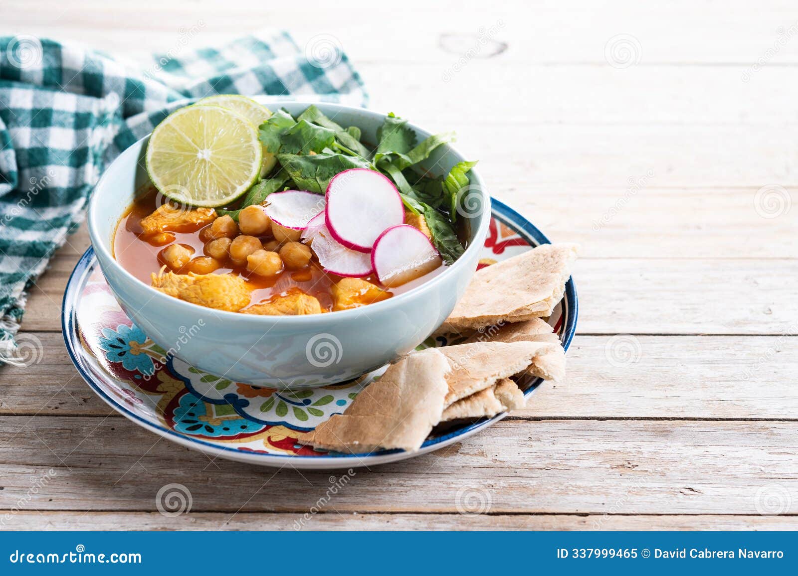 traditional mexican red pozole soup on wooden table