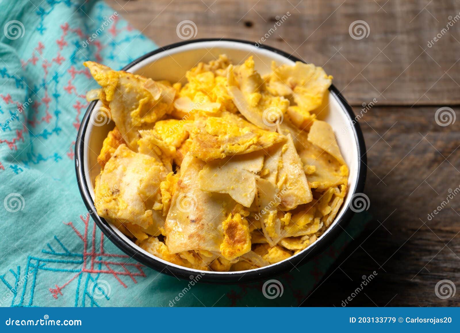 Mexican Scrambled Eggs with Corn Tortilla Also Called Migas on Wooden