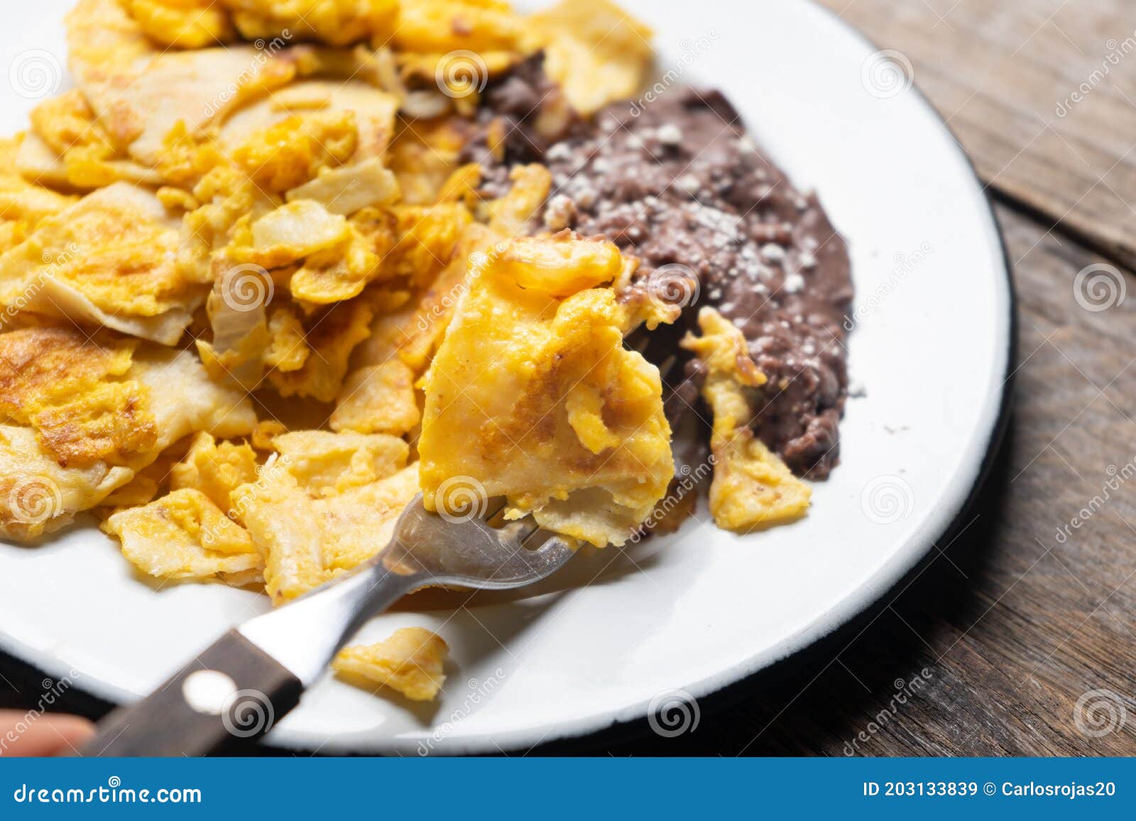 Mexican Scrambled Eggs with Corn Tortilla Also Called Migas on Wooden