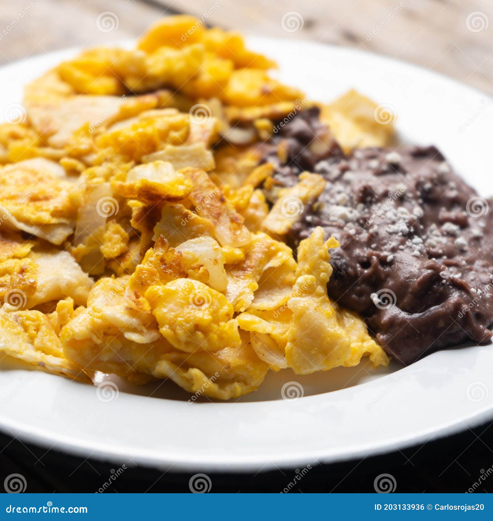 Mexican Scrambled Eggs with Corn Tortilla Also Called Migas on Wooden